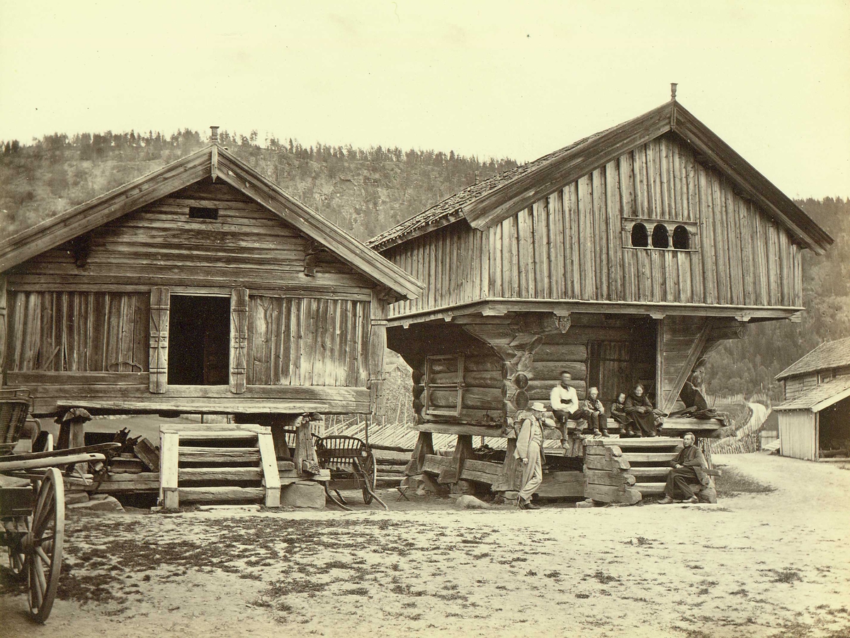 Fra gårdstun med ant. loft og stabbur, Semb, Heddal, Notodden, Telemark. Persongruppe.
Fra serie norske landskapsfotografier tatt av den engelske fotografen Henry Rosling (1828-1911).