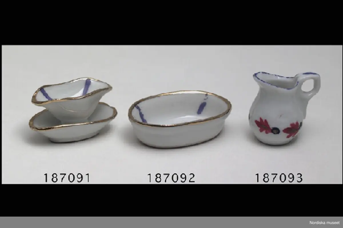 Inventering Sesam 1996-1999:
H 1,5 cm
H 4 cm
Oval såsskål av porslin, fat och skål i ett, förgyllda kanter, 4 blå streck i skålen.
Tillhör dockskåp 187.063 (se dess kat.kort för mer info).
Leif Wallin 1996