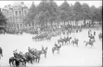 Parad på Gustaf V:s födelsedag 1928. Förbimarsch för platschefen överste Reuterswärd på skolplan framför Eric Ugglas skola. I bakgrunden till vänster milostabsbyggnaden.