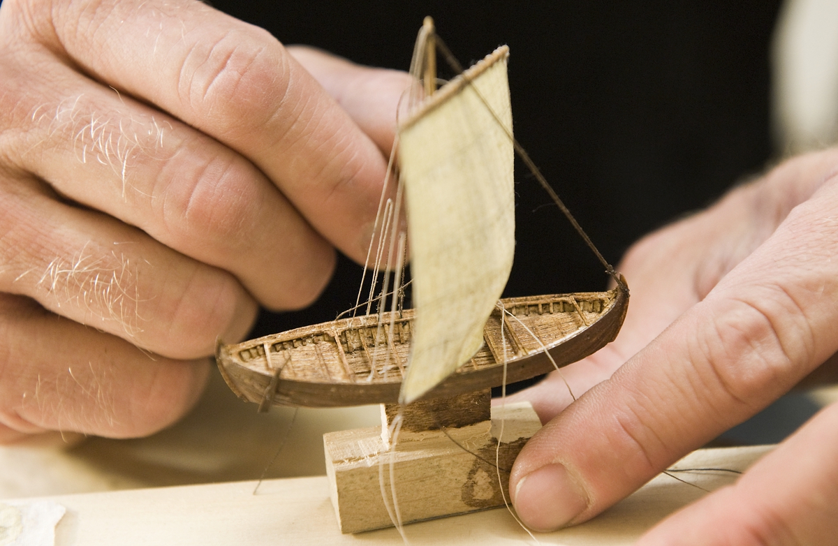 Modellbyggare Stefan Brun i arbete med en modell i skala 1:200 till utställningen "Shipping & Shopping".