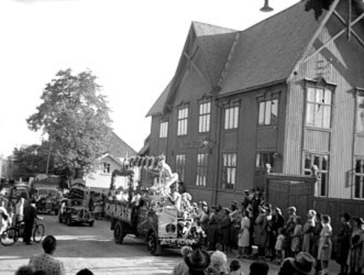 En samling bilder fra Skien, bl.a. Skiensdagene med opptog. Fruktaroma hadde 10-15 mann som gikk i oppdrag med kurver og delte ut vareprøver, samt 1 bilde fra krigen der tyske soldater marsjerer mot brakken på Gjemsø. Fotografiet er tatt fra bakken opp mot Sykekehuset. Borg ble oppdaget og tatt inn til forhør.