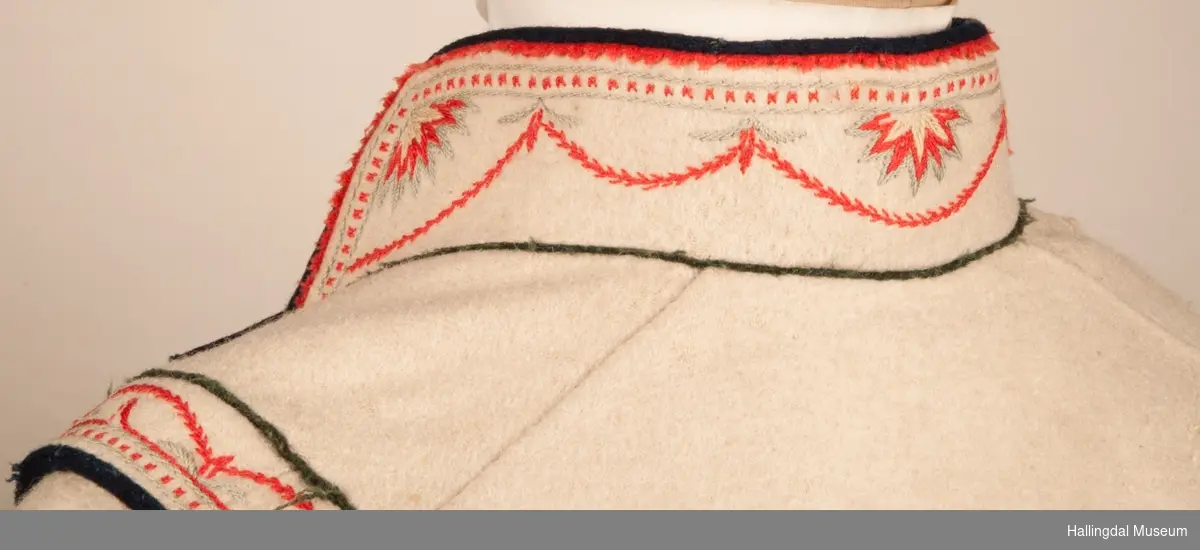 Brudgom fra Hallingdal ca. 1830. Brudgomsdrakten er satt sammen av mange plagg deriblant rød lang rød vest HFN 03616,kvit steglatrøye HFN 03615, høy hatt HFN 03086,  sokkeband HFN 01911 a-b,  knebukse HFN 2024, sko HFN 03124 a-b, skinnbelte HFN 01912, knesokker HFN 03618, kaste 03389 og silkesjal HFN 02004. Brudgommen har stått utstilt i den faste bunadutstillingen på Hallingdal Museum, Nesbyen fra 2009.