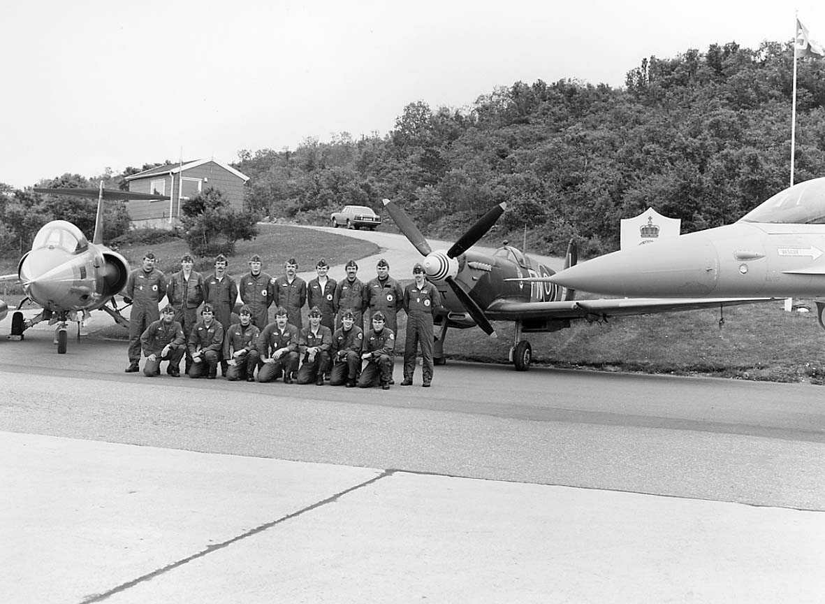 Gruppefoto av Jagerflypiloter med 3 forskjellige typer jagerfly plassert rundt dem.