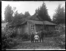 Nils, Hjärtum 1918-01-09, Erik, Hjärtum 1919-07-26, Sven, Hjärtum 1915-05-14, stående på framför tillbyggnaden på ladugården. I bakgrunden syns ett nytt uthus.