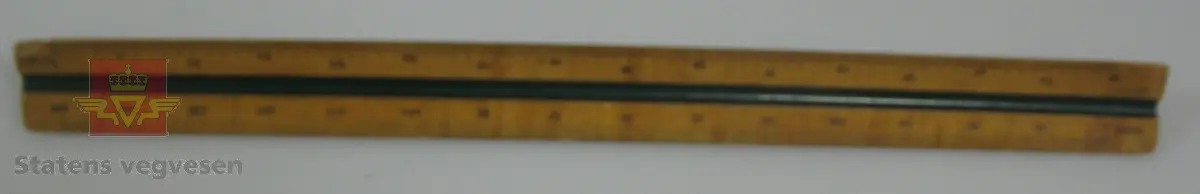 Trekantet linjal med påsatt mål i seks ulike målestokker fra 1:100 til 1:800. Lagd av tre.