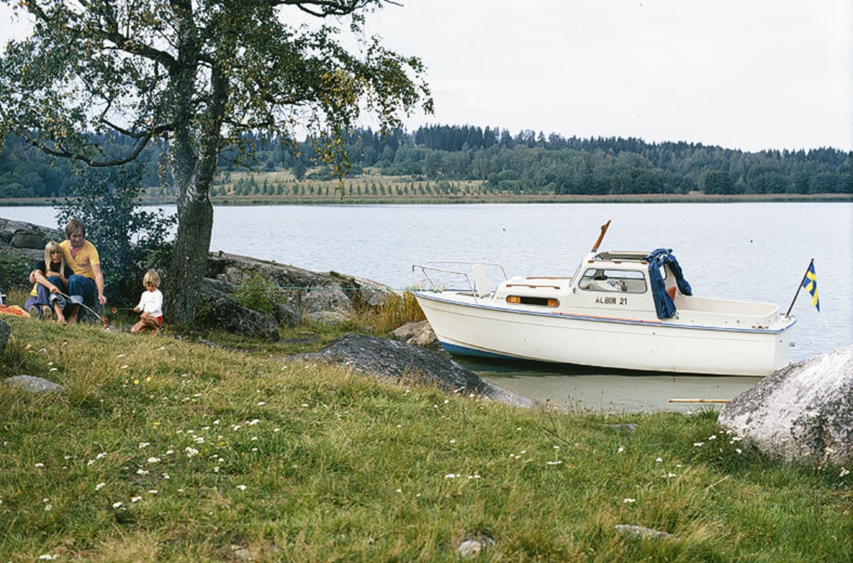 Albin 21 förtöjd i en vik. Marknadsföringsbild.