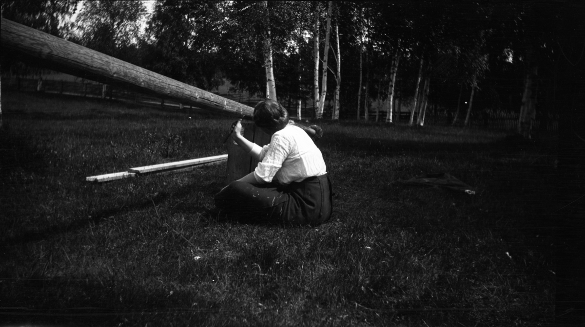 Fotoarkivet etter Gunnar Knudsen. En kvinne som maler en flaggstang fotografert