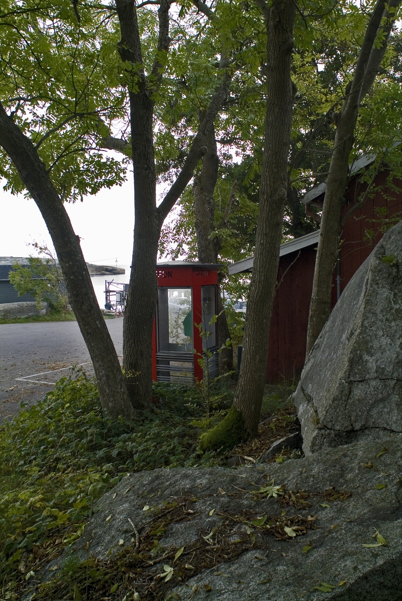 This is the story of how Norway’s most important conversation-space was designed by a young, freshly graduated man from Bergen.

“Norwegian architects are hereby invited…”
In the autumn of 1932, Oslo Telefonanlegginitiated an architectural competition. Finally, Oslo would get its own telephone booth. The city had had so called “talking-stations” from 1885, which in turn were overtaken by automatic telephones 
 only available at selected Narvesen kiosks. The state 
was of the opinion that now was the time to offer the public a better service; public telephone booths open 24/7, like the ones they already had in Sweden and England. But what would they look like, these new telephone booths? What considerations would it
 be necessary to take when designing it? The telegraph board developed a detailed list of demands and restraints: “The booth is intended to be placed outside on the streets and squares and need to be designed so that snow and ice does not hinder the opening and closing of the doors,” they wrote. “To prevent vandalism, theft, uncleanliness etc. inside the booth, it needs to be designed so that from all angles one may see what is going on in there.” Additionally, it would need to withstand storms and bad weather, and “preferably also being whipped by rain mixed with seawater” 

This was not all: The appearance would have to be «pleasing». The booth also needed to be movable, so that it could be taken in to be serviced at Telegrafverket’s main workshops. The reqired material was iron, and the surface was to be spray painted  preferably using car-body paint. There was a requirement for “a writing shelf, a pack shelf, and a suitable place for the telephone catalogue.” Also, there would need to be an illuminated TELEFON  sign, easily visible from all four angles. The total cost for each booth should not exceed 1000 kroner. The first prize for coming up with such a product was 800 kroner.

“Norwegianarchitects are hereby invited to partake in a competition for the design of a telephone booth…”  

The man with the solution
«At some point in 1932, Georg Fredrik sat at a party in Bergen. Maybe he felt a bit lost and forgotten as he often had throughout his life. He retreated to a quiet corner, took out a pencil and strted doodling on a matchbox.  According to my mother, this was how the telephone booth came into being.” In the book “Norges lille røde  historien om telefonkiosken,” Lars Fasting describes his father, the man who is far less known than the iconic architctural structure he left behind. Georg Fredrik Fasting was from Bergen, born into a family of working people and smallholders. One unusual facet of Georg Fredrik was that he was born without ears. His mother made sure he learnt to speak, read and write, 
ut Lars Fasting indicates that his father would seek refuge in drawing when the social challenges became too much to bear. And in the end drawing became his profession. In 1924 he secured a guarantor for a student loan, and started studying to become an a
rchitect at the NTH. Throughout the 1930s he entered several architectural competitions, with drafts produced, according to his son, “after work and in the late hours of the night.”

His efforts were not wasted. Out of 93 entries, with names such as “Flirt”, “Brrr”, “Ring” and “Amor”, the jury selected Fasting’s submission, “RIKS” as the new telephone booth: “The draft shows a strikingly simple solution to the task, technically as well as aesthetically well worked out.”

Taut and provident
Simple and aesthetc are the keywords here. Fasting had designed a booth pointing towards the future, and to modernism. Just how modern it was can be seen by comparing RIKS to the British telephone booth, also designed in the interwar-era. While the British version with it classicistic style is looking back to the heyday of the empire, Fasting’s booth is progressive and functionalistic. Like most Norwegian architects, Fasting broke with the classicistic style of architecture after the Stockholm-exhibition in 1930. “After it, almost all buildings erected in Norway until the German invasion in 1940, were in the functionalistic architectural style,” writes senior curator of architecture at the Norwegian National Museum, Ulf Grønvold, in the book, “Den lille røde”.“TheNorwegian booth is a piece of functionalistic architecture, an asymmetric composition with its roof slab overhanging the word TELEFON, in bold sans seraph lettering,”concludes Ulf Grønvold.

Fashionably red
And it was red. Fasting chose a colour which was part of the modern palette. “A bright red colour, but not as shiny as a signal red, the character of the colour places it among the fashionable colours within functionalism,” states paintings conservator and researcher in NIKU (Norwegian Institute for Cultural Heitage Research), Jon Brænne. In his opinion, Fasting went for visibility without making the booth stand out too much from its surroundings. The original colour was in use up to around 1950, when it changed to signal red. Towards the end of the 1970s the clour was again adjusted towards today’s orangey red.

The design, however, has not changed. RIKS is eighty years and still looks remarkably good. That’s what makes Fasting’s telephone booth a classic  even before it was added to DOCOMOMO’s list over moden icons of design. For Telenor, the telephone booth has served as a pathway into the hearts of the public. For many, Telenor (Televerket) was synonymous with exactly this telephone booth, because this was where one would go to place a call. Having a home
phone was not common until the 1980s. As such the red box became part of the Norwegian everyday and consciousness. The symbol- and publicity value of this is hard to evaluate, but in 2007 it was time to give honour where honour was due, Telenor, in consul
tation with the Directorate for Cultural Heritage, decided to preserve 100 telephone booths for all eternity.

And what about Georg Fredrik Fasting? What happened to him? At the age of 56 an entry in his diary states: «I CAN HEAR». As the first person in th world he had undergone an operation where he had ear canals constructed and eardrums fitted. For the rest of his life, the man behind Norway’s own telephone booth could answer the telephone himself.

Source: Norges lille røde historien om telefonkiosken (2007), issued by The Norwegian Telecom Museum and Telenor Cultural Heritage.