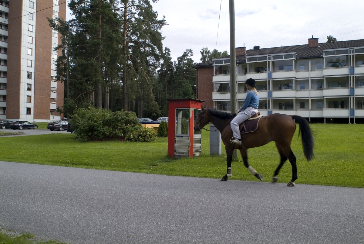 This is the story of how Norway’s most important conversation-space was designed by a young, freshly graduated man from Bergen.

“Norwegian architects are hereby invited…”
In the autumn of 1932, Oslo Telefonanlegginitiated an architectural competition. Finally, Oslo would get its own telephone booth. The city had had so called “talking-stations” from 1885, which in turn were overtaken by automatic telephones 
 only available at selected Narvesen kiosks. The state 
was of the opinion that now was the time to offer the public a better service; public telephone booths open 24/7, like the ones they already had in Sweden and England. But what would they look like, these new telephone booths? What considerations would it
 be necessary to take when designing it? The telegraph board developed a detailed list of demands and restraints: “The booth is intended to be placed outside on the streets and squares and need to be designed so that snow and ice does not hinder the opening and closing of the doors,” they wrote. “To prevent vandalism, theft, uncleanliness etc. inside the booth, it needs to be designed so that from all angles one may see what is going on in there.” Additionally, it would need to withstand storms and bad weather, and “preferably also being whipped by rain mixed with seawater” 

This was not all: The appearance would have to be «pleasing». The booth also needed to be movable, so that it could be taken in to be serviced at Telegrafverket’s main workshops. The reqired material was iron, and the surface was to be spray painted  preferably using car-body paint. There was a requirement for “a writing shelf, a pack shelf, and a suitable place for the telephone catalogue.” Also, there would need to be an illuminated TELEFON  sign, easily visible from all four angles. The total cost for each booth should not exceed 1000 kroner. The first prize for coming up with such a product was 800 kroner.

“Norwegianarchitects are hereby invited to partake in a competition for the design of a telephone booth…”  

The man with the solution
«At some point in 1932, Georg Fredrik sat at a party in Bergen. Maybe he felt a bit lost and forgotten as he often had throughout his life. He retreated to a quiet corner, took out a pencil and strted doodling on a matchbox.  According to my mother, this was how the telephone booth came into being.” In the book “Norges lille røde  historien om telefonkiosken,” Lars Fasting describes his father, the man who is far less known than the iconic architctural structure he left behind. Georg Fredrik Fasting was from Bergen, born into a family of working people and smallholders. One unusual facet of Georg Fredrik was that he was born without ears. His mother made sure he learnt to speak, read and write, 
ut Lars Fasting indicates that his father would seek refuge in drawing when the social challenges became too much to bear. And in the end drawing became his profession. In 1924 he secured a guarantor for a student loan, and started studying to become an a
rchitect at the NTH. Throughout the 1930s he entered several architectural competitions, with drafts produced, according to his son, “after work and in the late hours of the night.”

His efforts were not wasted. Out of 93 entries, with names such as “Flirt”, “Brrr”, “Ring” and “Amor”, the jury selected Fasting’s submission, “RIKS” as the new telephone booth: “The draft shows a strikingly simple solution to the task, technically as well as aesthetically well worked out.”

Taut and provident
Simple and aesthetc are the keywords here. Fasting had designed a booth pointing towards the future, and to modernism. Just how modern it was can be seen by comparing RIKS to the British telephone booth, also designed in the interwar-era. While the British version with it classicistic style is looking back to the heyday of the empire, Fasting’s booth is progressive and functionalistic. Like most Norwegian architects, Fasting broke with the classicistic style of architecture after the Stockholm-exhibition in 1930. “After it, almost all buildings erected in Norway until the German invasion in 1940, were in the functionalistic architectural style,” writes senior curator of architecture at the Norwegian National Museum, Ulf Grønvold, in the book, “Den lille røde”.“TheNorwegian booth is a piece of functionalistic architecture, an asymmetric composition with its roof slab overhanging the word TELEFON, in bold sans seraph lettering,”concludes Ulf Grønvold.

Fashionably red
And it was red. Fasting chose a colour which was part of the modern palette. “A bright red colour, but not as shiny as a signal red, the character of the colour places it among the fashionable colours within functionalism,” states paintings conservator and researcher in NIKU (Norwegian Institute for Cultural Heitage Research), Jon Brænne. In his opinion, Fasting went for visibility without making the booth stand out too much from its surroundings. The original colour was in use up to around 1950, when it changed to signal red. Towards the end of the 1970s the clour was again adjusted towards today’s orangey red.

The design, however, has not changed. RIKS is eighty years and still looks remarkably good. That’s what makes Fasting’s telephone booth a classic  even before it was added to DOCOMOMO’s list over moden icons of design. For Telenor, the telephone booth has served as a pathway into the hearts of the public. For many, Telenor (Televerket) was synonymous with exactly this telephone booth, because this was where one would go to place a call. Having a home
phone was not common until the 1980s. As such the red box became part of the Norwegian everyday and consciousness. The symbol- and publicity value of this is hard to evaluate, but in 2007 it was time to give honour where honour was due, Telenor, in consul
tation with the Directorate for Cultural Heritage, decided to preserve 100 telephone booths for all eternity.

And what about Georg Fredrik Fasting? What happened to him? At the age of 56 an entry in his diary states: «I CAN HEAR». As the first person in th world he had undergone an operation where he had ear canals constructed and eardrums fitted. For the rest of his life, the man behind Norway’s own telephone booth could answer the telephone himself.

Source: Norges lille røde historien om telefonkiosken (2007), issued by The Norwegian Telecom Museum and Telenor Cultural Heritage.