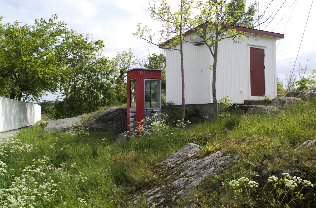 This is the story of how Norway’s most important conversation-space was designed by a young, freshly graduated man from Bergen.

“Norwegian architects are hereby invited…”
In the autumn of 1932, Oslo Telefonanlegginitiated an architectural competition. Finally, Oslo would get its own telephone booth. The city had had so called “talking-stations” from 1885, which in turn were overtaken by automatic telephones 
 only available at selected Narvesen kiosks. The state 
was of the opinion that now was the time to offer the public a better service; public telephone booths open 24/7, like the ones they already had in Sweden and England. But what would they look like, these new telephone booths? What considerations would it
 be necessary to take when designing it? The telegraph board developed a detailed list of demands and restraints: “The booth is intended to be placed outside on the streets and squares and need to be designed so that snow and ice does not hinder the opening and closing of the doors,” they wrote. “To prevent vandalism, theft, uncleanliness etc. inside the booth, it needs to be designed so that from all angles one may see what is going on in there.” Additionally, it would need to withstand storms and bad weather, and “preferably also being whipped by rain mixed with seawater” 

This was not all: The appearance would have to be «pleasing». The booth also needed to be movable, so that it could be taken in to be serviced at Telegrafverket’s main workshops. The reqired material was iron, and the surface was to be spray painted  preferably using car-body paint. There was a requirement for “a writing shelf, a pack shelf, and a suitable place for the telephone catalogue.” Also, there would need to be an illuminated TELEFON  sign, easily visible from all four angles. The total cost for each booth should not exceed 1000 kroner. The first prize for coming up with such a product was 800 kroner.

“Norwegianarchitects are hereby invited to partake in a competition for the design of a telephone booth…”  

The man with the solution
«At some point in 1932, Georg Fredrik sat at a party in Bergen. Maybe he felt a bit lost and forgotten as he often had throughout his life. He retreated to a quiet corner, took out a pencil and strted doodling on a matchbox.  According to my mother, this was how the telephone booth came into being.” In the book “Norges lille røde  historien om telefonkiosken,” Lars Fasting describes his father, the man who is far less known than the iconic architctural structure he left behind. Georg Fredrik Fasting was from Bergen, born into a family of working people and smallholders. One unusual facet of Georg Fredrik was that he was born without ears. His mother made sure he learnt to speak, read and write, 
ut Lars Fasting indicates that his father would seek refuge in drawing when the social challenges became too much to bear. And in the end drawing became his profession. In 1924 he secured a guarantor for a student loan, and started studying to become an a
rchitect at the NTH. Throughout the 1930s he entered several architectural competitions, with drafts produced, according to his son, “after work and in the late hours of the night.”

His efforts were not wasted. Out of 93 entries, with names such as “Flirt”, “Brrr”, “Ring” and “Amor”, the jury selected Fasting’s submission, “RIKS” as the new telephone booth: “The draft shows a strikingly simple solution to the task, technically as well as aesthetically well worked out.”

Taut and provident
Simple and aesthetc are the keywords here. Fasting had designed a booth pointing towards the future, and to modernism. Just how modern it was can be seen by comparing RIKS to the British telephone booth, also designed in the interwar-era. While the British version with it classicistic style is looking back to the heyday of the empire, Fasting’s booth is progressive and functionalistic. Like most Norwegian architects, Fasting broke with the classicistic style of architecture after the Stockholm-exhibition in 1930. “After it, almost all buildings erected in Norway until the German invasion in 1940, were in the functionalistic architectural style,” writes senior curator of architecture at the Norwegian National Museum, Ulf Grønvold, in the book, “Den lille røde”.“TheNorwegian booth is a piece of functionalistic architecture, an asymmetric composition with its roof slab overhanging the word TELEFON, in bold sans seraph lettering,”concludes Ulf Grønvold.

Fashionably red
And it was red. Fasting chose a colour which was part of the modern palette. “A bright red colour, but not as shiny as a signal red, the character of the colour places it among the fashionable colours within functionalism,” states paintings conservator and researcher in NIKU (Norwegian Institute for Cultural Heitage Research), Jon Brænne. In his opinion, Fasting went for visibility without making the booth stand out too much from its surroundings. The original colour was in use up to around 1950, when it changed to signal red. Towards the end of the 1970s the clour was again adjusted towards today’s orangey red.

The design, however, has not changed. RIKS is eighty years and still looks remarkably good. That’s what makes Fasting’s telephone booth a classic  even before it was added to DOCOMOMO’s list over moden icons of design. For Telenor, the telephone booth has served as a pathway into the hearts of the public. For many, Telenor (Televerket) was synonymous with exactly this telephone booth, because this was where one would go to place a call. Having a home
phone was not common until the 1980s. As such the red box became part of the Norwegian everyday and consciousness. The symbol- and publicity value of this is hard to evaluate, but in 2007 it was time to give honour where honour was due, Telenor, in consul
tation with the Directorate for Cultural Heritage, decided to preserve 100 telephone booths for all eternity.

And what about Georg Fredrik Fasting? What happened to him? At the age of 56 an entry in his diary states: «I CAN HEAR». As the first person in th world he had undergone an operation where he had ear canals constructed and eardrums fitted. For the rest of his life, the man behind Norway’s own telephone booth could answer the telephone himself.

Source: Norges lille røde historien om telefonkiosken (2007), issued by The Norwegian Telecom Museum and Telenor Cultural Heritage.