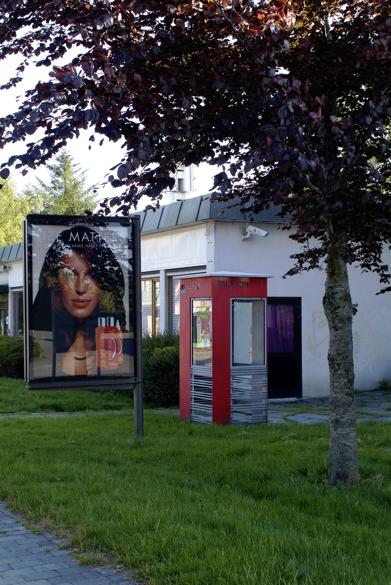 This is the story of how Norway’s most important conversation-space was designed by a young, freshly graduated man from Bergen.

“Norwegian architects are hereby invited…”
In the autumn of 1932, Oslo Telefonanlegginitiated an architectural competition. Finally, Oslo would get its own telephone booth. The city had had so called “talking-stations” from 1885, which in turn were overtaken by automatic telephones 
 only available at selected Narvesen kiosks. The state 
was of the opinion that now was the time to offer the public a better service; public telephone booths open 24/7, like the ones they already had in Sweden and England. But what would they look like, these new telephone booths? What considerations would it
 be necessary to take when designing it? The telegraph board developed a detailed list of demands and restraints: “The booth is intended to be placed outside on the streets and squares and need to be designed so that snow and ice does not hinder the opening and closing of the doors,” they wrote. “To prevent vandalism, theft, uncleanliness etc. inside the booth, it needs to be designed so that from all angles one may see what is going on in there.” Additionally, it would need to withstand storms and bad weather, and “preferably also being whipped by rain mixed with seawater” 

This was not all: The appearance would have to be «pleasing». The booth also needed to be movable, so that it could be taken in to be serviced at Telegrafverket’s main workshops. The reqired material was iron, and the surface was to be spray painted  preferably using car-body paint. There was a requirement for “a writing shelf, a pack shelf, and a suitable place for the telephone catalogue.” Also, there would need to be an illuminated TELEFON  sign, easily visible from all four angles. The total cost for each booth should not exceed 1000 kroner. The first prize for coming up with such a product was 800 kroner.

“Norwegianarchitects are hereby invited to partake in a competition for the design of a telephone booth…”  

The man with the solution
«At some point in 1932, Georg Fredrik sat at a party in Bergen. Maybe he felt a bit lost and forgotten as he often had throughout his life. He retreated to a quiet corner, took out a pencil and strted doodling on a matchbox.  According to my mother, this was how the telephone booth came into being.” In the book “Norges lille røde  historien om telefonkiosken,” Lars Fasting describes his father, the man who is far less known than the iconic architctural structure he left behind. Georg Fredrik Fasting was from Bergen, born into a family of working people and smallholders. One unusual facet of Georg Fredrik was that he was born without ears. His mother made sure he learnt to speak, read and write, 
ut Lars Fasting indicates that his father would seek refuge in drawing when the social challenges became too much to bear. And in the end drawing became his profession. In 1924 he secured a guarantor for a student loan, and started studying to become an a
rchitect at the NTH. Throughout the 1930s he entered several architectural competitions, with drafts produced, according to his son, “after work and in the late hours of the night.”

His efforts were not wasted. Out of 93 entries, with names such as “Flirt”, “Brrr”, “Ring” and “Amor”, the jury selected Fasting’s submission, “RIKS” as the new telephone booth: “The draft shows a strikingly simple solution to the task, technically as well as aesthetically well worked out.”

Taut and provident
Simple and aesthetc are the keywords here. Fasting had designed a booth pointing towards the future, and to modernism. Just how modern it was can be seen by comparing RIKS to the British telephone booth, also designed in the interwar-era. While the British version with it classicistic style is looking back to the heyday of the empire, Fasting’s booth is progressive and functionalistic. Like most Norwegian architects, Fasting broke with the classicistic style of architecture after the Stockholm-exhibition in 1930. “After it, almost all buildings erected in Norway until the German invasion in 1940, were in the functionalistic architectural style,” writes senior curator of architecture at the Norwegian National Museum, Ulf Grønvold, in the book, “Den lille røde”.“TheNorwegian booth is a piece of functionalistic architecture, an asymmetric composition with its roof slab overhanging the word TELEFON, in bold sans seraph lettering,”concludes Ulf Grønvold.

Fashionably red
And it was red. Fasting chose a colour which was part of the modern palette. “A bright red colour, but not as shiny as a signal red, the character of the colour places it among the fashionable colours within functionalism,” states paintings conservator and researcher in NIKU (Norwegian Institute for Cultural Heitage Research), Jon Brænne. In his opinion, Fasting went for visibility without making the booth stand out too much from its surroundings. The original colour was in use up to around 1950, when it changed to signal red. Towards the end of the 1970s the clour was again adjusted towards today’s orangey red.

The design, however, has not changed. RIKS is eighty years and still looks remarkably good. That’s what makes Fasting’s telephone booth a classic  even before it was added to DOCOMOMO’s list over moden icons of design. For Telenor, the telephone booth has served as a pathway into the hearts of the public. For many, Telenor (Televerket) was synonymous with exactly this telephone booth, because this was where one would go to place a call. Having a home
phone was not common until the 1980s. As such the red box became part of the Norwegian everyday and consciousness. The symbol- and publicity value of this is hard to evaluate, but in 2007 it was time to give honour where honour was due, Telenor, in consul
tation with the Directorate for Cultural Heritage, decided to preserve 100 telephone booths for all eternity.

And what about Georg Fredrik Fasting? What happened to him? At the age of 56 an entry in his diary states: «I CAN HEAR». As the first person in th world he had undergone an operation where he had ear canals constructed and eardrums fitted. For the rest of his life, the man behind Norway’s own telephone booth could answer the telephone himself.

Source: Norges lille røde historien om telefonkiosken (2007), issued by The Norwegian Telecom Museum and Telenor Cultural Heritage.