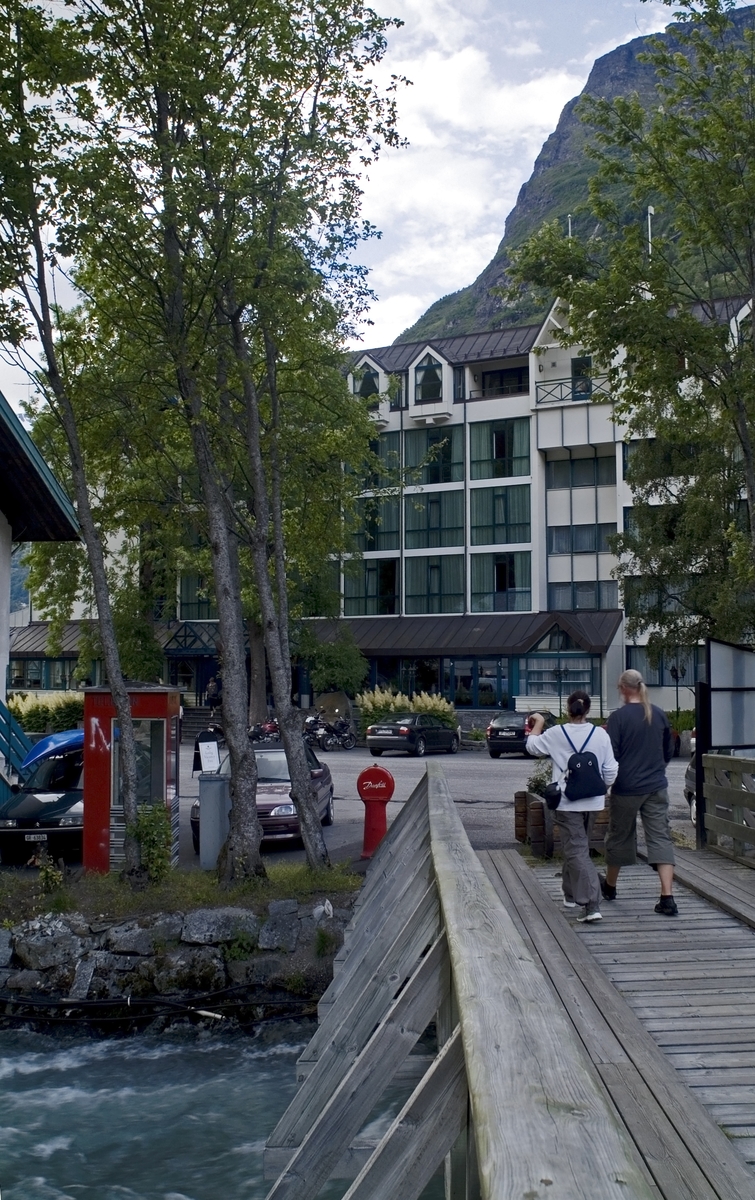 This is the story of how Norway’s most important conversation-space was designed by a young, freshly graduated man from Bergen.

“Norwegian architects are hereby invited…”
In the autumn of 1932, Oslo Telefonanlegginitiated an architectural competition. Finally, Oslo would get its own telephone booth. The city had had so called “talking-stations” from 1885, which in turn were overtaken by automatic telephones 
 only available at selected Narvesen kiosks. The state 
was of the opinion that now was the time to offer the public a better service; public telephone booths open 24/7, like the ones they already had in Sweden and England. But what would they look like, these new telephone booths? What considerations would it
 be necessary to take when designing it? The telegraph board developed a detailed list of demands and restraints: “The booth is intended to be placed outside on the streets and squares and need to be designed so that snow and ice does not hinder the opening and closing of the doors,” they wrote. “To prevent vandalism, theft, uncleanliness etc. inside the booth, it needs to be designed so that from all angles one may see what is going on in there.” Additionally, it would need to withstand storms and bad weather, and “preferably also being whipped by rain mixed with seawater” 

This was not all: The appearance would have to be «pleasing». The booth also needed to be movable, so that it could be taken in to be serviced at Telegrafverket’s main workshops. The reqired material was iron, and the surface was to be spray painted  preferably using car-body paint. There was a requirement for “a writing shelf, a pack shelf, and a suitable place for the telephone catalogue.” Also, there would need to be an illuminated TELEFON  sign, easily visible from all four angles. The total cost for each booth should not exceed 1000 kroner. The first prize for coming up with such a product was 800 kroner.

“Norwegianarchitects are hereby invited to partake in a competition for the design of a telephone booth…”  

The man with the solution
«At some point in 1932, Georg Fredrik sat at a party in Bergen. Maybe he felt a bit lost and forgotten as he often had throughout his life. He retreated to a quiet corner, took out a pencil and strted doodling on a matchbox.  According to my mother, this was how the telephone booth came into being.” In the book “Norges lille røde  historien om telefonkiosken,” Lars Fasting describes his father, the man who is far less known than the iconic architctural structure he left behind. Georg Fredrik Fasting was from Bergen, born into a family of working people and smallholders. One unusual facet of Georg Fredrik was that he was born without ears. His mother made sure he learnt to speak, read and write, 
ut Lars Fasting indicates that his father would seek refuge in drawing when the social challenges became too much to bear. And in the end drawing became his profession. In 1924 he secured a guarantor for a student loan, and started studying to become an a
rchitect at the NTH. Throughout the 1930s he entered several architectural competitions, with drafts produced, according to his son, “after work and in the late hours of the night.”

His efforts were not wasted. Out of 93 entries, with names such as “Flirt”, “Brrr”, “Ring” and “Amor”, the jury selected Fasting’s submission, “RIKS” as the new telephone booth: “The draft shows a strikingly simple solution to the task, technically as well as aesthetically well worked out.”

Taut and provident
Simple and aesthetc are the keywords here. Fasting had designed a booth pointing towards the future, and to modernism. Just how modern it was can be seen by comparing RIKS to the British telephone booth, also designed in the interwar-era. While the British version with it classicistic style is looking back to the heyday of the empire, Fasting’s booth is progressive and functionalistic. Like most Norwegian architects, Fasting broke with the classicistic style of architecture after the Stockholm-exhibition in 1930. “After it, almost all buildings erected in Norway until the German invasion in 1940, were in the functionalistic architectural style,” writes senior curator of architecture at the Norwegian National Museum, Ulf Grønvold, in the book, “Den lille røde”.“TheNorwegian booth is a piece of functionalistic architecture, an asymmetric composition with its roof slab overhanging the word TELEFON, in bold sans seraph lettering,”concludes Ulf Grønvold.

Fashionably red
And it was red. Fasting chose a colour which was part of the modern palette. “A bright red colour, but not as shiny as a signal red, the character of the colour places it among the fashionable colours within functionalism,” states paintings conservator and researcher in NIKU (Norwegian Institute for Cultural Heitage Research), Jon Brænne. In his opinion, Fasting went for visibility without making the booth stand out too much from its surroundings. The original colour was in use up to around 1950, when it changed to signal red. Towards the end of the 1970s the clour was again adjusted towards today’s orangey red.

The design, however, has not changed. RIKS is eighty years and still looks remarkably good. That’s what makes Fasting’s telephone booth a classic  even before it was added to DOCOMOMO’s list over moden icons of design. For Telenor, the telephone booth has served as a pathway into the hearts of the public. For many, Telenor (Televerket) was synonymous with exactly this telephone booth, because this was where one would go to place a call. Having a home
phone was not common until the 1980s. As such the red box became part of the Norwegian everyday and consciousness. The symbol- and publicity value of this is hard to evaluate, but in 2007 it was time to give honour where honour was due, Telenor, in consul
tation with the Directorate for Cultural Heritage, decided to preserve 100 telephone booths for all eternity.

And what about Georg Fredrik Fasting? What happened to him? At the age of 56 an entry in his diary states: «I CAN HEAR». As the first person in th world he had undergone an operation where he had ear canals constructed and eardrums fitted. For the rest of his life, the man behind Norway’s own telephone booth could answer the telephone himself.

Source: Norges lille røde historien om telefonkiosken (2007), issued by The Norwegian Telecom Museum and Telenor Cultural Heritage.