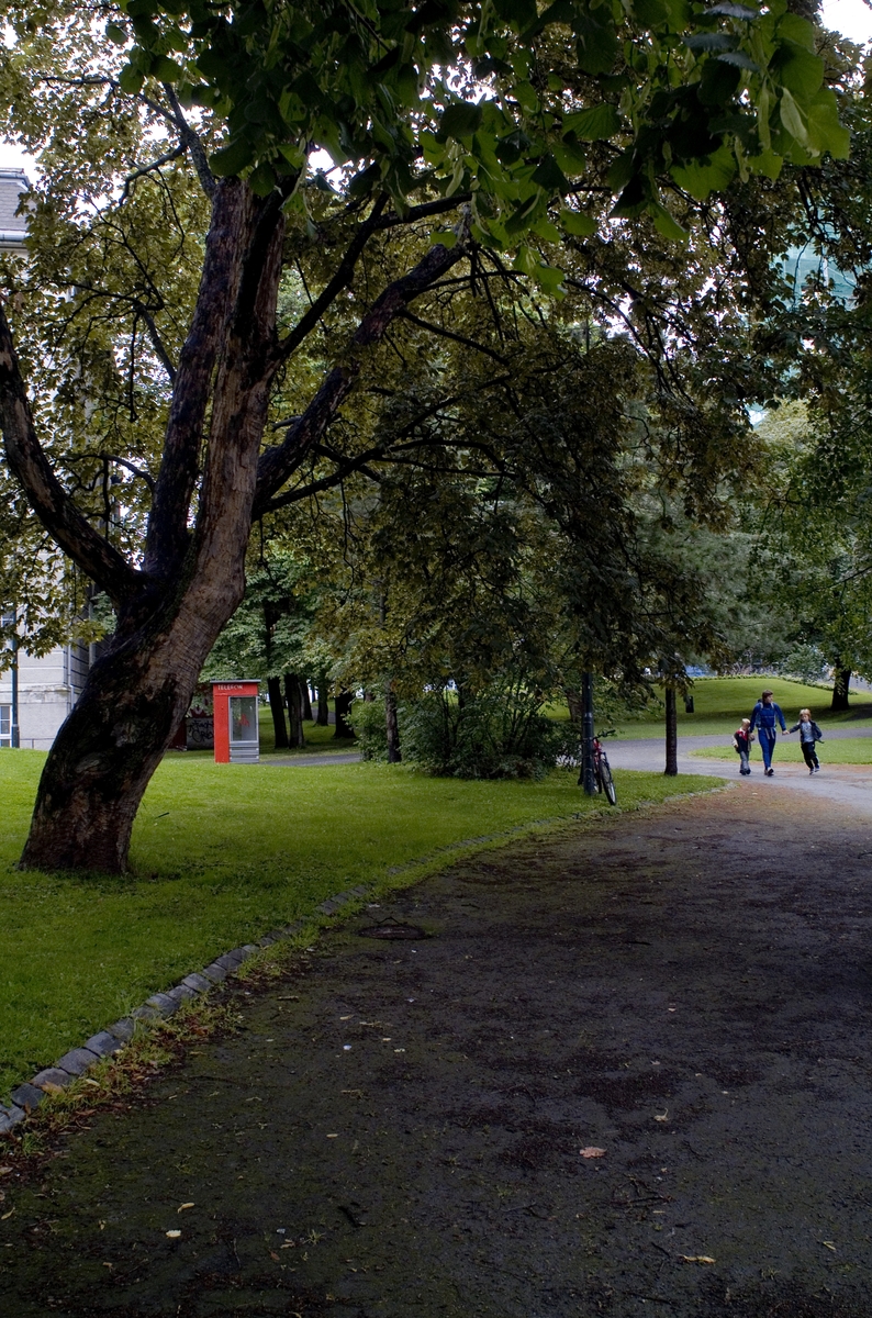 This is the story of how Norway’s most important conversation-space was designed by a young, freshly graduated man from Bergen.

“Norwegian architects are hereby invited…”
In the autumn of 1932, Oslo Telefonanlegginitiated an architectural competition. Finally, Oslo would get its own telephone booth. The city had had so called “talking-stations” from 1885, which in turn were overtaken by automatic telephones 
 only available at selected Narvesen kiosks. The state 
was of the opinion that now was the time to offer the public a better service; public telephone booths open 24/7, like the ones they already had in Sweden and England. But what would they look like, these new telephone booths? What considerations would it
 be necessary to take when designing it? The telegraph board developed a detailed list of demands and restraints: “The booth is intended to be placed outside on the streets and squares and need to be designed so that snow and ice does not hinder the opening and closing of the doors,” they wrote. “To prevent vandalism, theft, uncleanliness etc. inside the booth, it needs to be designed so that from all angles one may see what is going on in there.” Additionally, it would need to withstand storms and bad weather, and “preferably also being whipped by rain mixed with seawater” 

This was not all: The appearance would have to be «pleasing». The booth also needed to be movable, so that it could be taken in to be serviced at Telegrafverket’s main workshops. The reqired material was iron, and the surface was to be spray painted  preferably using car-body paint. There was a requirement for “a writing shelf, a pack shelf, and a suitable place for the telephone catalogue.” Also, there would need to be an illuminated TELEFON  sign, easily visible from all four angles. The total cost for each booth should not exceed 1000 kroner. The first prize for coming up with such a product was 800 kroner.

“Norwegianarchitects are hereby invited to partake in a competition for the design of a telephone booth…”  

The man with the solution
«At some point in 1932, Georg Fredrik sat at a party in Bergen. Maybe he felt a bit lost and forgotten as he often had throughout his life. He retreated to a quiet corner, took out a pencil and strted doodling on a matchbox.  According to my mother, this was how the telephone booth came into being.” In the book “Norges lille røde  historien om telefonkiosken,” Lars Fasting describes his father, the man who is far less known than the iconic architctural structure he left behind. Georg Fredrik Fasting was from Bergen, born into a family of working people and smallholders. One unusual facet of Georg Fredrik was that he was born without ears. His mother made sure he learnt to speak, read and write, 
ut Lars Fasting indicates that his father would seek refuge in drawing when the social challenges became too much to bear. And in the end drawing became his profession. In 1924 he secured a guarantor for a student loan, and started studying to become an a
rchitect at the NTH. Throughout the 1930s he entered several architectural competitions, with drafts produced, according to his son, “after work and in the late hours of the night.”

His efforts were not wasted. Out of 93 entries, with names such as “Flirt”, “Brrr”, “Ring” and “Amor”, the jury selected Fasting’s submission, “RIKS” as the new telephone booth: “The draft shows a strikingly simple solution to the task, technically as well as aesthetically well worked out.”

Taut and provident
Simple and aesthetc are the keywords here. Fasting had designed a booth pointing towards the future, and to modernism. Just how modern it was can be seen by comparing RIKS to the British telephone booth, also designed in the interwar-era. While the British version with it classicistic style is looking back to the heyday of the empire, Fasting’s booth is progressive and functionalistic. Like most Norwegian architects, Fasting broke with the classicistic style of architecture after the Stockholm-exhibition in 1930. “After it, almost all buildings erected in Norway until the German invasion in 1940, were in the functionalistic architectural style,” writes senior curator of architecture at the Norwegian National Museum, Ulf Grønvold, in the book, “Den lille røde”.“TheNorwegian booth is a piece of functionalistic architecture, an asymmetric composition with its roof slab overhanging the word TELEFON, in bold sans seraph lettering,”concludes Ulf Grønvold.

Fashionably red
And it was red. Fasting chose a colour which was part of the modern palette. “A bright red colour, but not as shiny as a signal red, the character of the colour places it among the fashionable colours within functionalism,” states paintings conservator and researcher in NIKU (Norwegian Institute for Cultural Heitage Research), Jon Brænne. In his opinion, Fasting went for visibility without making the booth stand out too much from its surroundings. The original colour was in use up to around 1950, when it changed to signal red. Towards the end of the 1970s the clour was again adjusted towards today’s orangey red.

The design, however, has not changed. RIKS is eighty years and still looks remarkably good. That’s what makes Fasting’s telephone booth a classic  even before it was added to DOCOMOMO’s list over moden icons of design. For Telenor, the telephone booth has served as a pathway into the hearts of the public. For many, Telenor (Televerket) was synonymous with exactly this telephone booth, because this was where one would go to place a call. Having a home
phone was not common until the 1980s. As such the red box became part of the Norwegian everyday and consciousness. The symbol- and publicity value of this is hard to evaluate, but in 2007 it was time to give honour where honour was due, Telenor, in consul
tation with the Directorate for Cultural Heritage, decided to preserve 100 telephone booths for all eternity.

And what about Georg Fredrik Fasting? What happened to him? At the age of 56 an entry in his diary states: «I CAN HEAR». As the first person in th world he had undergone an operation where he had ear canals constructed and eardrums fitted. For the rest of his life, the man behind Norway’s own telephone booth could answer the telephone himself.

Source: Norges lille røde historien om telefonkiosken (2007), issued by The Norwegian Telecom Museum and Telenor Cultural Heritage.