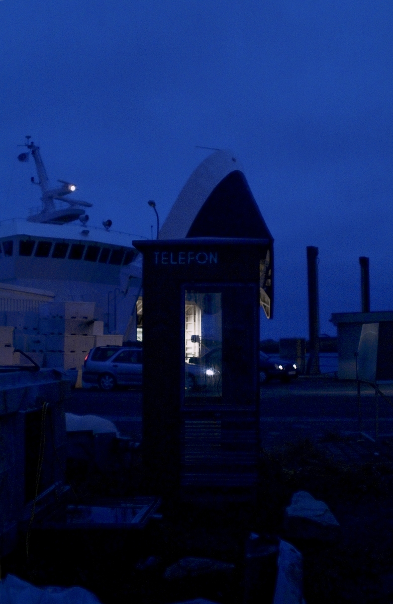 This is the story of how Norway’s most important conversation-space was designed by a young, freshly graduated man from Bergen.

“Norwegian architects are hereby invited…”
In the autumn of 1932, Oslo Telefonanlegginitiated an architectural competition. Finally, Oslo would get its own telephone booth. The city had had so called “talking-stations” from 1885, which in turn were overtaken by automatic telephones 
 only available at selected Narvesen kiosks. The state 
was of the opinion that now was the time to offer the public a better service; public telephone booths open 24/7, like the ones they already had in Sweden and England. But what would they look like, these new telephone booths? What considerations would it
 be necessary to take when designing it? The telegraph board developed a detailed list of demands and restraints: “The booth is intended to be placed outside on the streets and squares and need to be designed so that snow and ice does not hinder the opening and closing of the doors,” they wrote. “To prevent vandalism, theft, uncleanliness etc. inside the booth, it needs to be designed so that from all angles one may see what is going on in there.” Additionally, it would need to withstand storms and bad weather, and “preferably also being whipped by rain mixed with seawater” 

This was not all: The appearance would have to be «pleasing». The booth also needed to be movable, so that it could be taken in to be serviced at Telegrafverket’s main workshops. The reqired material was iron, and the surface was to be spray painted  preferably using car-body paint. There was a requirement for “a writing shelf, a pack shelf, and a suitable place for the telephone catalogue.” Also, there would need to be an illuminated TELEFON  sign, easily visible from all four angles. The total cost for each booth should not exceed 1000 kroner. The first prize for coming up with such a product was 800 kroner.

“Norwegianarchitects are hereby invited to partake in a competition for the design of a telephone booth…”  

The man with the solution
«At some point in 1932, Georg Fredrik sat at a party in Bergen. Maybe he felt a bit lost and forgotten as he often had throughout his life. He retreated to a quiet corner, took out a pencil and strted doodling on a matchbox.  According to my mother, this was how the telephone booth came into being.” In the book “Norges lille røde  historien om telefonkiosken,” Lars Fasting describes his father, the man who is far less known than the iconic architctural structure he left behind. Georg Fredrik Fasting was from Bergen, born into a family of working people and smallholders. One unusual facet of Georg Fredrik was that he was born without ears. His mother made sure he learnt to speak, read and write, 
ut Lars Fasting indicates that his father would seek refuge in drawing when the social challenges became too much to bear. And in the end drawing became his profession. In 1924 he secured a guarantor for a student loan, and started studying to become an a
rchitect at the NTH. Throughout the 1930s he entered several architectural competitions, with drafts produced, according to his son, “after work and in the late hours of the night.”

His efforts were not wasted. Out of 93 entries, with names such as “Flirt”, “Brrr”, “Ring” and “Amor”, the jury selected Fasting’s submission, “RIKS” as the new telephone booth: “The draft shows a strikingly simple solution to the task, technically as well as aesthetically well worked out.”

Taut and provident
Simple and aesthetc are the keywords here. Fasting had designed a booth pointing towards the future, and to modernism. Just how modern it was can be seen by comparing RIKS to the British telephone booth, also designed in the interwar-era. While the British version with it classicistic style is looking back to the heyday of the empire, Fasting’s booth is progressive and functionalistic. Like most Norwegian architects, Fasting broke with the classicistic style of architecture after the Stockholm-exhibition in 1930. “After it, almost all buildings erected in Norway until the German invasion in 1940, were in the functionalistic architectural style,” writes senior curator of architecture at the Norwegian National Museum, Ulf Grønvold, in the book, “Den lille røde”.“TheNorwegian booth is a piece of functionalistic architecture, an asymmetric composition with its roof slab overhanging the word TELEFON, in bold sans seraph lettering,”concludes Ulf Grønvold.

Fashionably red
And it was red. Fasting chose a colour which was part of the modern palette. “A bright red colour, but not as shiny as a signal red, the character of the colour places it among the fashionable colours within functionalism,” states paintings conservator and researcher in NIKU (Norwegian Institute for Cultural Heitage Research), Jon Brænne. In his opinion, Fasting went for visibility without making the booth stand out too much from its surroundings. The original colour was in use up to around 1950, when it changed to signal red. Towards the end of the 1970s the clour was again adjusted towards today’s orangey red.

The design, however, has not changed. RIKS is eighty years and still looks remarkably good. That’s what makes Fasting’s telephone booth a classic  even before it was added to DOCOMOMO’s list over moden icons of design. For Telenor, the telephone booth has served as a pathway into the hearts of the public. For many, Telenor (Televerket) was synonymous with exactly this telephone booth, because this was where one would go to place a call. Having a home
phone was not common until the 1980s. As such the red box became part of the Norwegian everyday and consciousness. The symbol- and publicity value of this is hard to evaluate, but in 2007 it was time to give honour where honour was due, Telenor, in consul
tation with the Directorate for Cultural Heritage, decided to preserve 100 telephone booths for all eternity.

And what about Georg Fredrik Fasting? What happened to him? At the age of 56 an entry in his diary states: «I CAN HEAR». As the first person in th world he had undergone an operation where he had ear canals constructed and eardrums fitted. For the rest of his life, the man behind Norway’s own telephone booth could answer the telephone himself.

Source: Norges lille røde historien om telefonkiosken (2007), issued by The Norwegian Telecom Museum and Telenor Cultural Heritage.