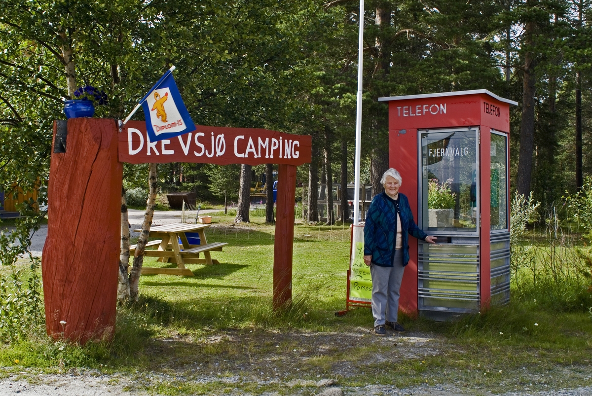 This is the story of how Norway’s most important conversation-space was designed by a young, freshly graduated man from Bergen.

“Norwegian architects are hereby invited…”
In the autumn of 1932, Oslo Telefonanlegginitiated an architectural competition. Finally, Oslo would get its own telephone booth. The city had had so called “talking-stations” from 1885, which in turn were overtaken by automatic telephones 
 only available at selected Narvesen kiosks. The state 
was of the opinion that now was the time to offer the public a better service; public telephone booths open 24/7, like the ones they already had in Sweden and England. But what would they look like, these new telephone booths? What considerations would it
 be necessary to take when designing it? The telegraph board developed a detailed list of demands and restraints: “The booth is intended to be placed outside on the streets and squares and need to be designed so that snow and ice does not hinder the opening and closing of the doors,” they wrote. “To prevent vandalism, theft, uncleanliness etc. inside the booth, it needs to be designed so that from all angles one may see what is going on in there.” Additionally, it would need to withstand storms and bad weather, and “preferably also being whipped by rain mixed with seawater” 

This was not all: The appearance would have to be «pleasing». The booth also needed to be movable, so that it could be taken in to be serviced at Telegrafverket’s main workshops. The reqired material was iron, and the surface was to be spray painted  preferably using car-body paint. There was a requirement for “a writing shelf, a pack shelf, and a suitable place for the telephone catalogue.” Also, there would need to be an illuminated TELEFON  sign, easily visible from all four angles. The total cost for each booth should not exceed 1000 kroner. The first prize for coming up with such a product was 800 kroner.

“Norwegianarchitects are hereby invited to partake in a competition for the design of a telephone booth…”  

The man with the solution
«At some point in 1932, Georg Fredrik sat at a party in Bergen. Maybe he felt a bit lost and forgotten as he often had throughout his life. He retreated to a quiet corner, took out a pencil and strted doodling on a matchbox.  According to my mother, this was how the telephone booth came into being.” In the book “Norges lille røde  historien om telefonkiosken,” Lars Fasting describes his father, the man who is far less known than the iconic architctural structure he left behind. Georg Fredrik Fasting was from Bergen, born into a family of working people and smallholders. One unusual facet of Georg Fredrik was that he was born without ears. His mother made sure he learnt to speak, read and write, 
ut Lars Fasting indicates that his father would seek refuge in drawing when the social challenges became too much to bear. And in the end drawing became his profession. In 1924 he secured a guarantor for a student loan, and started studying to become an a
rchitect at the NTH. Throughout the 1930s he entered several architectural competitions, with drafts produced, according to his son, “after work and in the late hours of the night.”

His efforts were not wasted. Out of 93 entries, with names such as “Flirt”, “Brrr”, “Ring” and “Amor”, the jury selected Fasting’s submission, “RIKS” as the new telephone booth: “The draft shows a strikingly simple solution to the task, technically as well as aesthetically well worked out.”

Taut and provident
Simple and aesthetc are the keywords here. Fasting had designed a booth pointing towards the future, and to modernism. Just how modern it was can be seen by comparing RIKS to the British telephone booth, also designed in the interwar-era. While the British version with it classicistic style is looking back to the heyday of the empire, Fasting’s booth is progressive and functionalistic. Like most Norwegian architects, Fasting broke with the classicistic style of architecture after the Stockholm-exhibition in 1930. “After it, almost all buildings erected in Norway until the German invasion in 1940, were in the functionalistic architectural style,” writes senior curator of architecture at the Norwegian National Museum, Ulf Grønvold, in the book, “Den lille røde”.“TheNorwegian booth is a piece of functionalistic architecture, an asymmetric composition with its roof slab overhanging the word TELEFON, in bold sans seraph lettering,”concludes Ulf Grønvold.

Fashionably red
And it was red. Fasting chose a colour which was part of the modern palette. “A bright red colour, but not as shiny as a signal red, the character of the colour places it among the fashionable colours within functionalism,” states paintings conservator and researcher in NIKU (Norwegian Institute for Cultural Heitage Research), Jon Brænne. In his opinion, Fasting went for visibility without making the booth stand out too much from its surroundings. The original colour was in use up to around 1950, when it changed to signal red. Towards the end of the 1970s the clour was again adjusted towards today’s orangey red.

The design, however, has not changed. RIKS is eighty years and still looks remarkably good. That’s what makes Fasting’s telephone booth a classic  even before it was added to DOCOMOMO’s list over moden icons of design. For Telenor, the telephone booth has served as a pathway into the hearts of the public. For many, Telenor (Televerket) was synonymous with exactly this telephone booth, because this was where one would go to place a call. Having a home
phone was not common until the 1980s. As such the red box became part of the Norwegian everyday and consciousness. The symbol- and publicity value of this is hard to evaluate, but in 2007 it was time to give honour where honour was due, Telenor, in consul
tation with the Directorate for Cultural Heritage, decided to preserve 100 telephone booths for all eternity.

And what about Georg Fredrik Fasting? What happened to him? At the age of 56 an entry in his diary states: «I CAN HEAR». As the first person in th world he had undergone an operation where he had ear canals constructed and eardrums fitted. For the rest of his life, the man behind Norway’s own telephone booth could answer the telephone himself.

Source: Norges lille røde historien om telefonkiosken (2007), issued by The Norwegian Telecom Museum and Telenor Cultural Heritage.