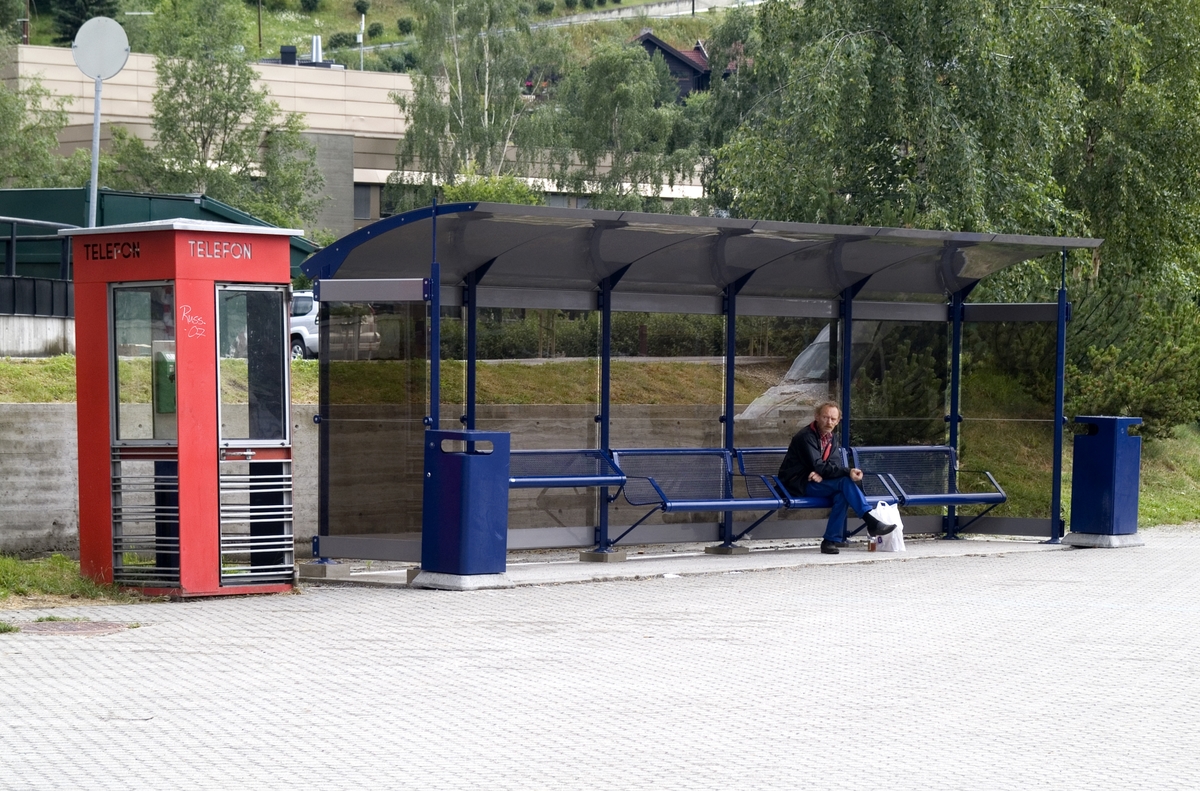 This is the story of how Norway’s most important conversation-space was designed by a young, freshly graduated man from Bergen.

“Norwegian architects are hereby invited…”
In the autumn of 1932, Oslo Telefonanlegginitiated an architectural competition. Finally, Oslo would get its own telephone booth. The city had had so called “talking-stations” from 1885, which in turn were overtaken by automatic telephones 
 only available at selected Narvesen kiosks. The state 
was of the opinion that now was the time to offer the public a better service; public telephone booths open 24/7, like the ones they already had in Sweden and England. But what would they look like, these new telephone booths? What considerations would it
 be necessary to take when designing it? The telegraph board developed a detailed list of demands and restraints: “The booth is intended to be placed outside on the streets and squares and need to be designed so that snow and ice does not hinder the opening and closing of the doors,” they wrote. “To prevent vandalism, theft, uncleanliness etc. inside the booth, it needs to be designed so that from all angles one may see what is going on in there.” Additionally, it would need to withstand storms and bad weather, and “preferably also being whipped by rain mixed with seawater” 

This was not all: The appearance would have to be «pleasing». The booth also needed to be movable, so that it could be taken in to be serviced at Telegrafverket’s main workshops. The reqired material was iron, and the surface was to be spray painted  preferably using car-body paint. There was a requirement for “a writing shelf, a pack shelf, and a suitable place for the telephone catalogue.” Also, there would need to be an illuminated TELEFON  sign, easily visible from all four angles. The total cost for each booth should not exceed 1000 kroner. The first prize for coming up with such a product was 800 kroner.

“Norwegianarchitects are hereby invited to partake in a competition for the design of a telephone booth…”  

The man with the solution
«At some point in 1932, Georg Fredrik sat at a party in Bergen. Maybe he felt a bit lost and forgotten as he often had throughout his life. He retreated to a quiet corner, took out a pencil and strted doodling on a matchbox.  According to my mother, this was how the telephone booth came into being.” In the book “Norges lille røde  historien om telefonkiosken,” Lars Fasting describes his father, the man who is far less known than the iconic architctural structure he left behind. Georg Fredrik Fasting was from Bergen, born into a family of working people and smallholders. One unusual facet of Georg Fredrik was that he was born without ears. His mother made sure he learnt to speak, read and write, 
ut Lars Fasting indicates that his father would seek refuge in drawing when the social challenges became too much to bear. And in the end drawing became his profession. In 1924 he secured a guarantor for a student loan, and started studying to become an a
rchitect at the NTH. Throughout the 1930s he entered several architectural competitions, with drafts produced, according to his son, “after work and in the late hours of the night.”

His efforts were not wasted. Out of 93 entries, with names such as “Flirt”, “Brrr”, “Ring” and “Amor”, the jury selected Fasting’s submission, “RIKS” as the new telephone booth: “The draft shows a strikingly simple solution to the task, technically as well as aesthetically well worked out.”

Taut and provident
Simple and aesthetc are the keywords here. Fasting had designed a booth pointing towards the future, and to modernism. Just how modern it was can be seen by comparing RIKS to the British telephone booth, also designed in the interwar-era. While the British version with it classicistic style is looking back to the heyday of the empire, Fasting’s booth is progressive and functionalistic. Like most Norwegian architects, Fasting broke with the classicistic style of architecture after the Stockholm-exhibition in 1930. “After it, almost all buildings erected in Norway until the German invasion in 1940, were in the functionalistic architectural style,” writes senior curator of architecture at the Norwegian National Museum, Ulf Grønvold, in the book, “Den lille røde”.“TheNorwegian booth is a piece of functionalistic architecture, an asymmetric composition with its roof slab overhanging the word TELEFON, in bold sans seraph lettering,”concludes Ulf Grønvold.

Fashionably red
And it was red. Fasting chose a colour which was part of the modern palette. “A bright red colour, but not as shiny as a signal red, the character of the colour places it among the fashionable colours within functionalism,” states paintings conservator and researcher in NIKU (Norwegian Institute for Cultural Heitage Research), Jon Brænne. In his opinion, Fasting went for visibility without making the booth stand out too much from its surroundings. The original colour was in use up to around 1950, when it changed to signal red. Towards the end of the 1970s the clour was again adjusted towards today’s orangey red.

The design, however, has not changed. RIKS is eighty years and still looks remarkably good. That’s what makes Fasting’s telephone booth a classic  even before it was added to DOCOMOMO’s list over moden icons of design. For Telenor, the telephone booth has served as a pathway into the hearts of the public. For many, Telenor (Televerket) was synonymous with exactly this telephone booth, because this was where one would go to place a call. Having a home
phone was not common until the 1980s. As such the red box became part of the Norwegian everyday and consciousness. The symbol- and publicity value of this is hard to evaluate, but in 2007 it was time to give honour where honour was due, Telenor, in consul
tation with the Directorate for Cultural Heritage, decided to preserve 100 telephone booths for all eternity.

And what about Georg Fredrik Fasting? What happened to him? At the age of 56 an entry in his diary states: «I CAN HEAR». As the first person in th world he had undergone an operation where he had ear canals constructed and eardrums fitted. For the rest of his life, the man behind Norway’s own telephone booth could answer the telephone himself.

Source: Norges lille røde historien om telefonkiosken (2007), issued by The Norwegian Telecom Museum and Telenor Cultural Heritage.