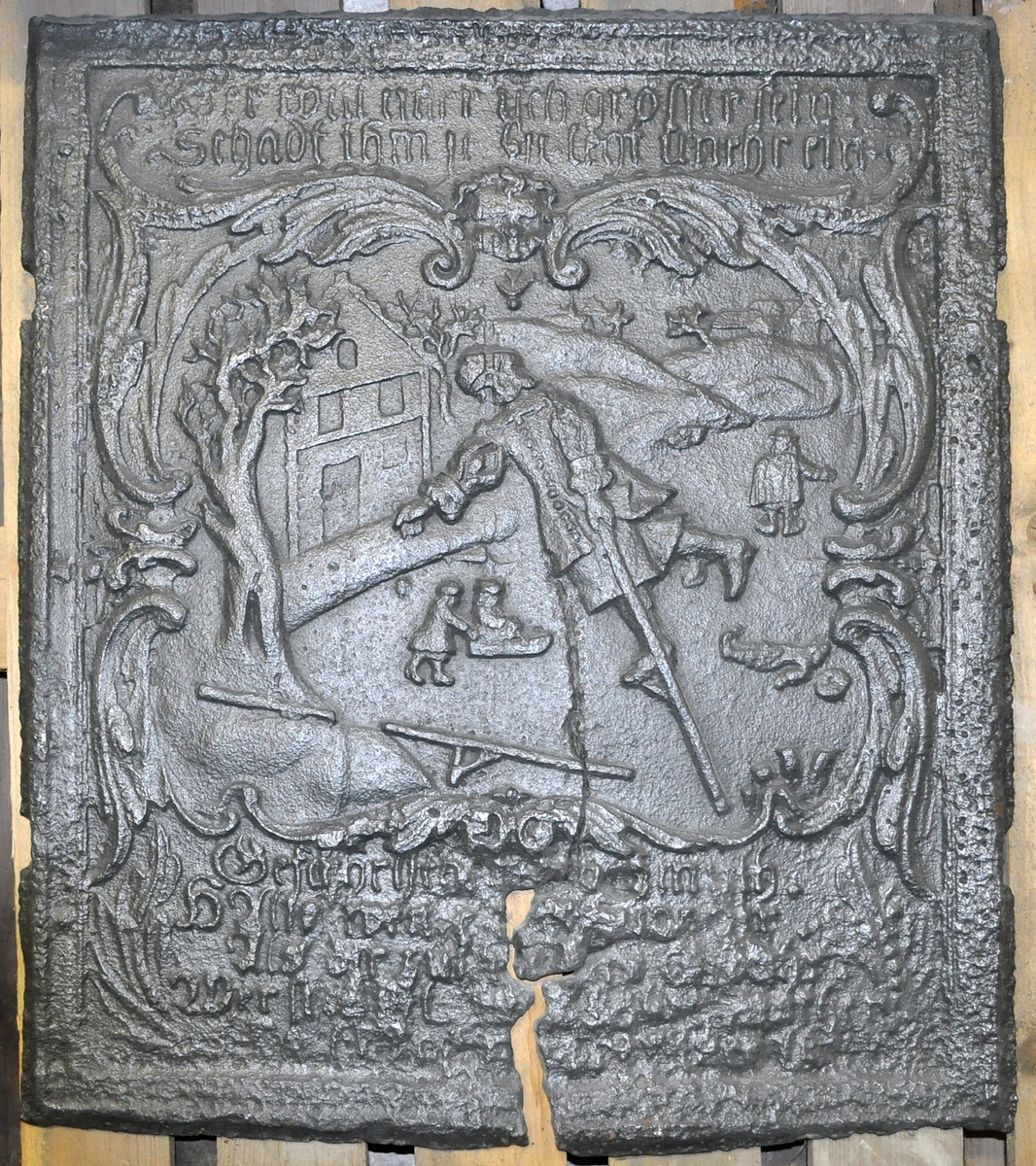 Fra protokollen (R. Berge):
Omn i ei høgd (botnplate vantar) med støypemynster i barok. Bakplata hev øvst denne innskrifti: "Alles thut in Jesu Nahm" "und so reths(?) drauf ein glaube Amen". 
Under denne ein stor sjaubladd blom, i kvart krunblad ordet: IESVS, i blomcentrum bokstavane A.M.E.N. Under blomen ymse motiv. Under desse att innskrifti: "Jesu beistand in der (Arbeit Jeder tag sein) Arbeit hat die uns mühel(?) früh und spät soll sie men von statten(?) gehen So müss Jesus bei dir stehen."
ST Anno (Jahr)  MT 1668 (Aarst. utydelegt).
Framstamnen som bakstamnen, men vantar alt som er nedanfor blomen.
Langsidune hev eit stort landskap, med ein islagd kanal(?), der ein mann gjeng paa (is)styltrur; han hev mist den eine og held paa aa dette i koll. Bak honom paa isen ser ein folk skuvar kvarandre paa kjolke. Bak kanalen landskap. Ikring bilætet er ei raame av baroksveivar. Yvi raama er ei innskrift, som luar: "Wer will närsisch(?) grösser sein Schadt ihm (je?) ... legt umehr ein."
Under bilætet au tysk innskrift, men støypingi er paa baae platune so utydeleg at ein fær kje samanheng i ho. 
Hyrneskinune vantar.