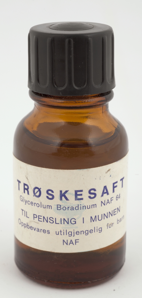 Medisinglass med skrukork av bakelitt.