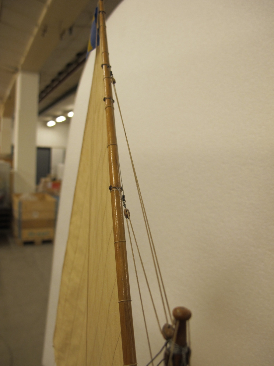 Segelkutter, skärgårdskryssaren ALCA. Fullständigt inredd med kajuta och sittrum. Modell byggd i ett trä. Riggad. Mast i en längd med gaffelsegel, fock och klyvare. Flagga och igenkänningsstandert. Vitmålad, röd botten. Fernissat däck och inredning. Stativ fernissat och förgyllt.
Alca var  45, 2 fot lång och 8,9 fot bred