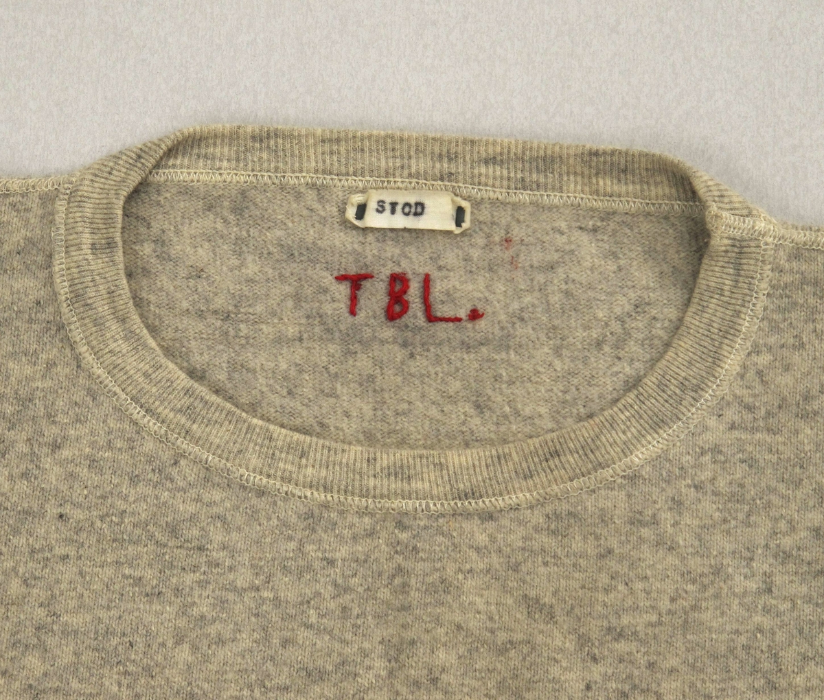 Maskinstrikket ullgenser.  Lys gråfarge.