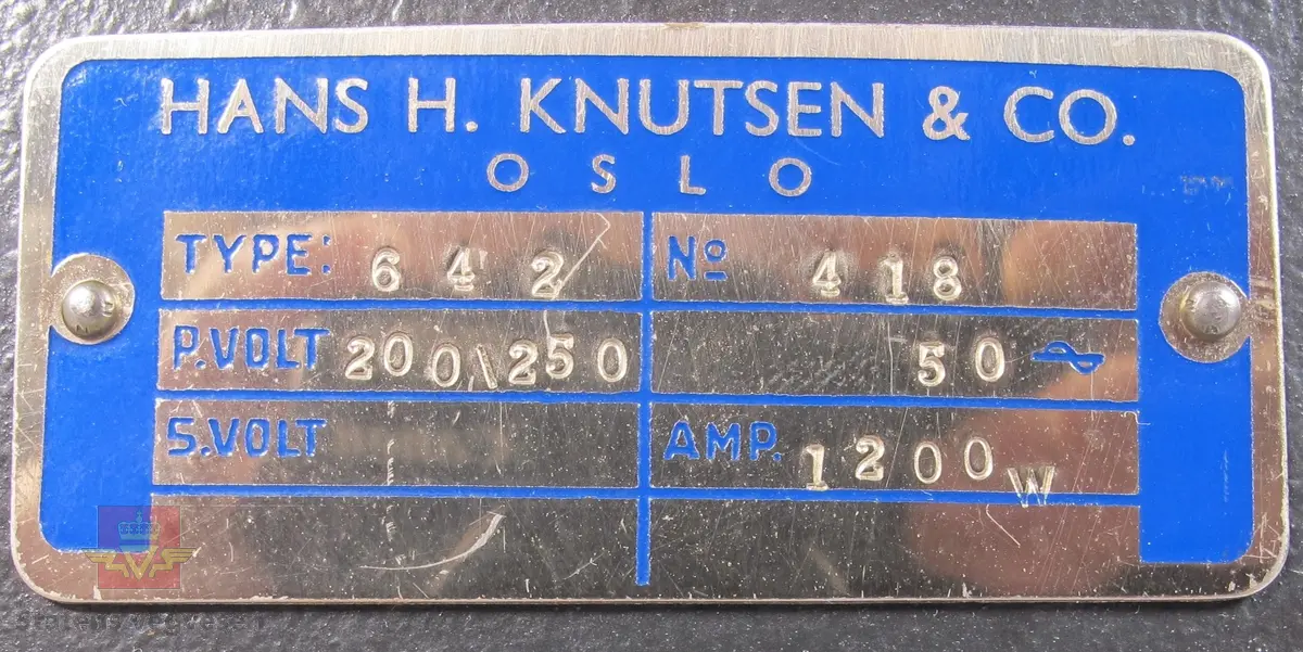 BELL & HOWELL MODEL 642. 16 mm filmfremviser i mørk grå koffert av glassfiber, med defekt bærehåndtak. Den ene delen av kofferten har høyttaler av merket Goodmans, ledning for tilkobling av høyttaler og to klistremerker med påskrifter. Filmfreviseren har eget panel for justering av lyden. Bak på kofferten er det to skiltplater med innskrifter, MODEL 642 SK SERIAL No. K418 220V-1100 W - 50 ~ MADE IN ENGLAND og HANS H. KNUTSEN & CO. OSLO TYPE 642 No 418 P.VOLT 200/250 50 ~ S.VOLT AMP. 1200W. Veske, strømledning, ekstra lyspære og to tomme filmruller følger med filmfremviseren.