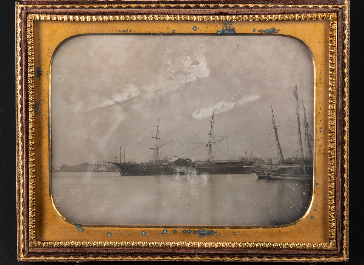 Daguerreotypi, föreställande varmluftsskeppet John Ericsson, infattad i ett läderetui med ornamentering. Locket fodrat med mönstrad röd silkessammet.