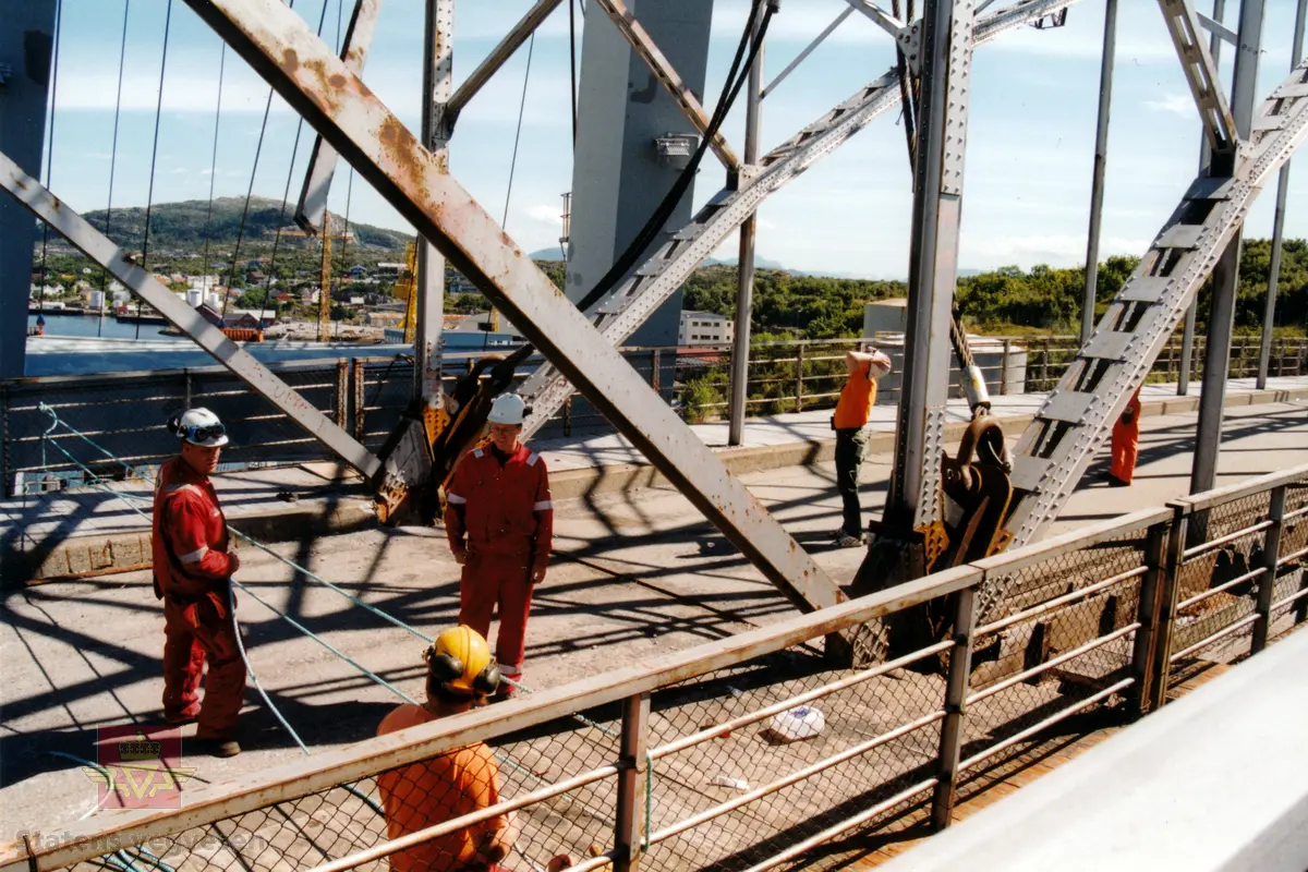 Operasjonen med å rive gamle Nordsund bru i Kristiansund 8. juli 1999. Planleggingsarbeidet hadde tatt ca 2 måneder og arbeidet skulle være ferdig 1. september.

Aktiviteten var stor og til tider hektisk i timene før brua skulle heves. Wirene til Kranskipet "Uglen" skimtes i bakgrunnen i det den har manøvrert seg til brua for å feste wirene til det 335 tonn tunge midtspennet. 

(Kilde: Statens vegvesen i Møre og Romsdal sitt interne magasin "Veg og Virke" nr. 3/1999. Artikkelen "No er gamle Nordsundet bru historie" av Reidun Øverland.)