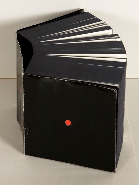 Vit kartong innehållande en svart blank kub med en röd liten prick. Innehåller papper med foton och text med japansk anknytning överst och anteckningspapper därunder.

Philipson.
Guldägg 1988.