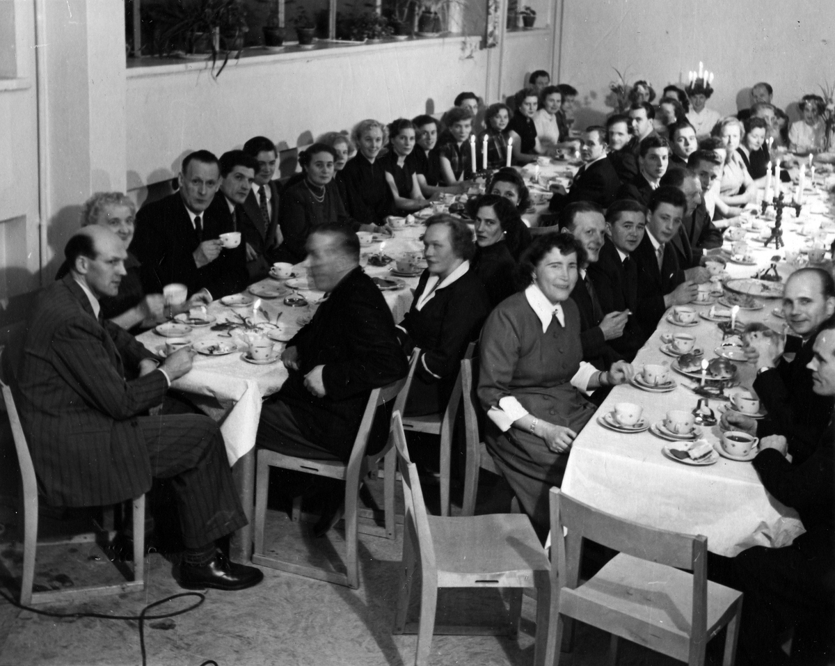 Två långbord fyllda med lussefirande personal på Sidenväveriet. 
Ur fotoalbum, påträffat i rivningsfastighet i kvarteret Friden 5.