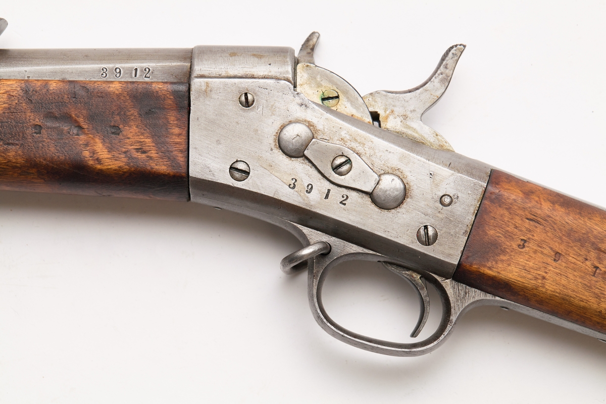 Bakladningsrifle. Remington latein for 1 patron. Kolbekappe, kolbe, lås, forskjefte, pipe og sikte har innslått 3912. Løpet har 6 høyrevridne rifler.
Under på pipens kammerende er mange merker: 1873   1   xJ  WA  ML  M  C. På pipens venstre side: 3912. På pipens høyre side: K med krone over. På låsets høyre side H med 1873 under. På låsets venstre side: 3912. Stillbart sikte til 1500 m. Bajonettfeste.