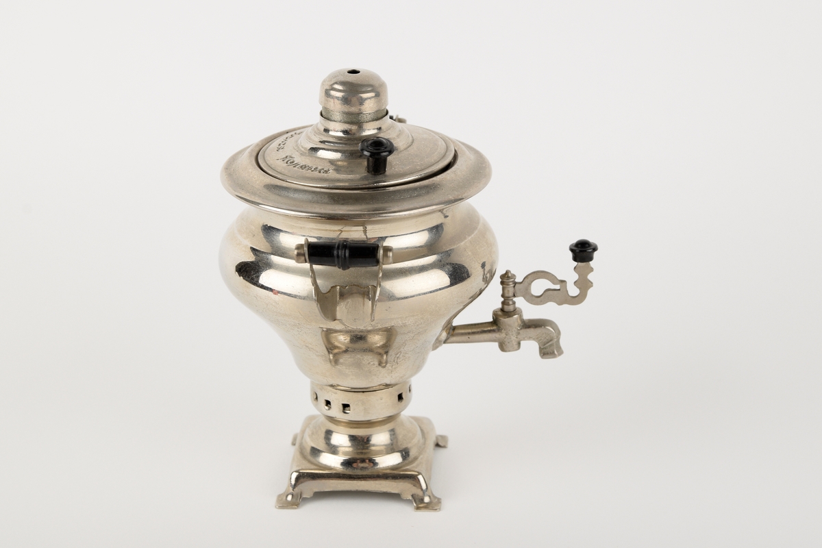 En liten russisk samovar, trolig kjøpt som suvenir. Innskrift på russisk (kyrillisk) på lokket.