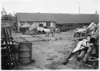 H län, Hamnförrådet i Kalmar. Avvecklades 1946. Översikt med diverse förrådsbyggnader, upplag av diverse material, 