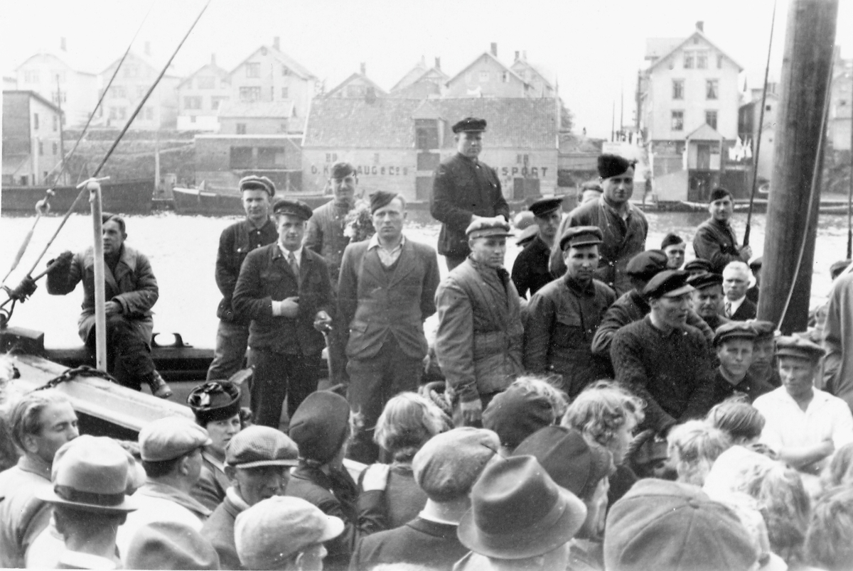 Feiring av freden 1945. Russiske eks-krigsfager på indre kai i Haugesund, avreisedagen den 31. mai.  Første stoppested skulle være en oppsamlingsleir i Stavanger. Sundet og Risøy i bakgrunnen.