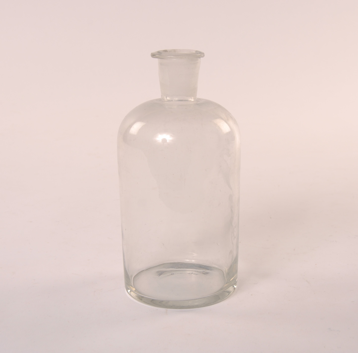 Flaske i klart glass, uten propp.