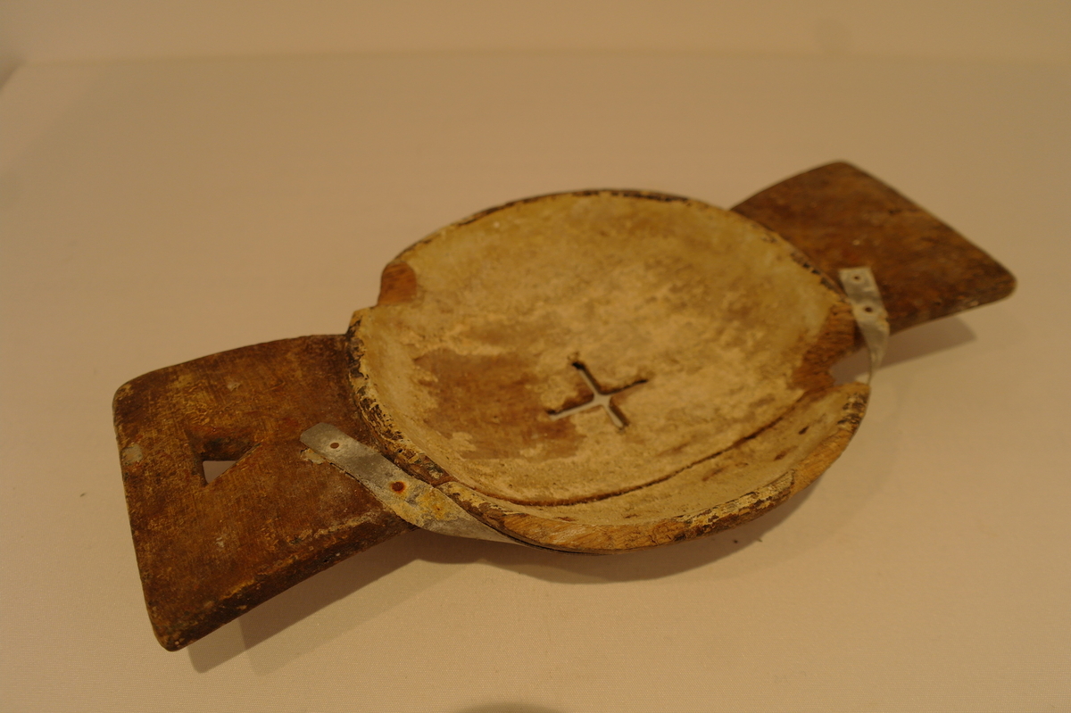 Liten mjølkesil i tre. Skåret frå eit stykke tre. Det er ein rund bolle i midten med eit hol forma som eit kross der mjølken skal silast igjennom. På kvar side av bollen er det handtak. Det eine handtaket har eit trekanta hol for oppheng. Det er ein stor sprekk i silen som er reparert med metallband som er spikra fast. Er prega av bruk og har to hakk i munningen.