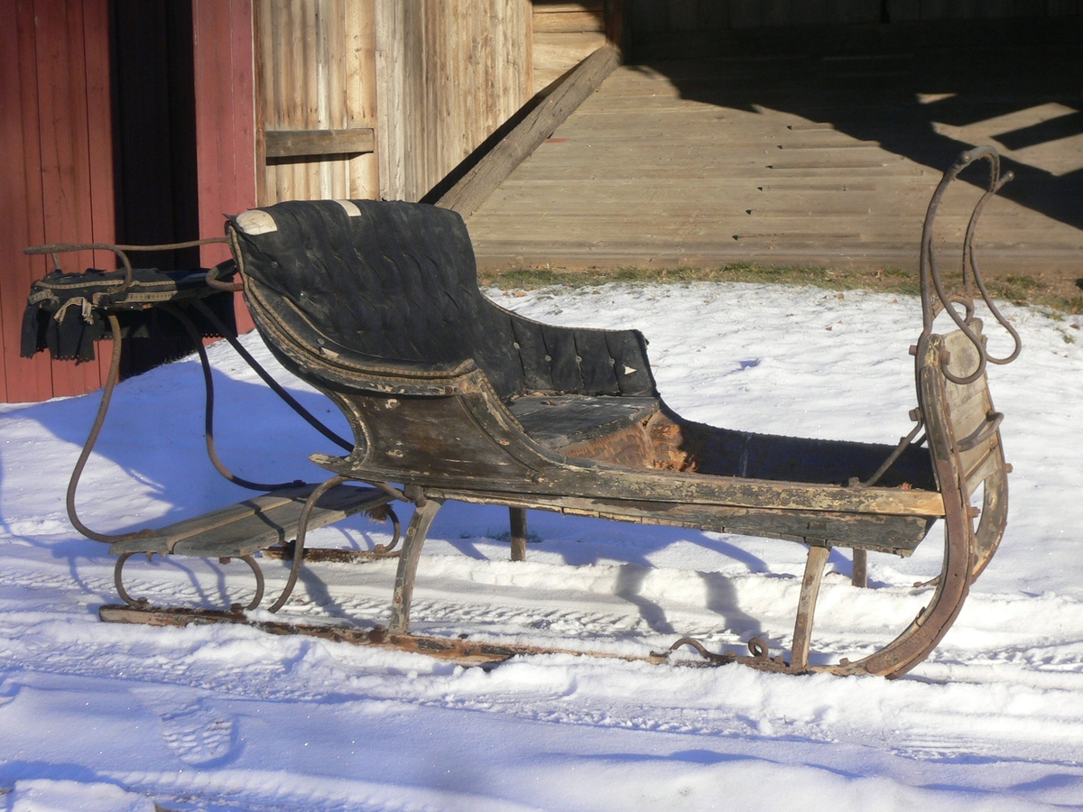 Slede for én hest til persontransport. Ett hovedsete  med svungen fasong for to personer. Hundsvott (sete) bak.