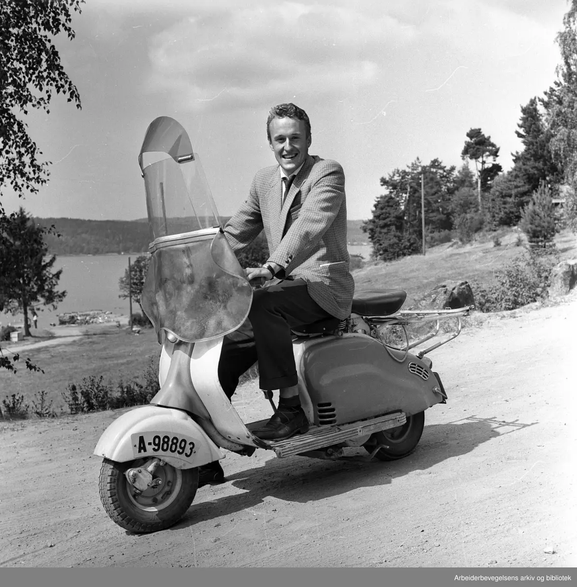 Finn-Erik Vinje på scooter, 1950-tallet.
