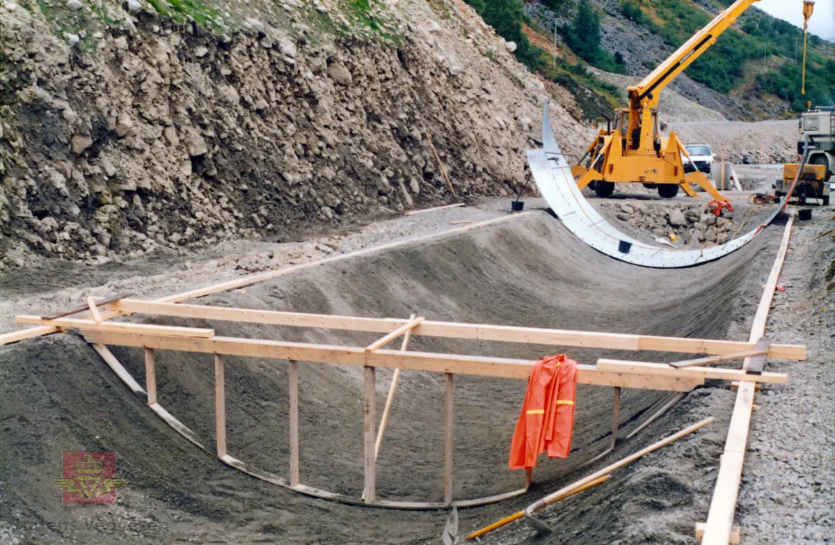 Rassikringstiltak ved Langeneset på fylkesveg 65 Festøya - Standal i Ørsta kommune.

Byggegrop i forbindelse med byggingen av et 129 meter stålrørtunnel/rasoverbygg ved Langeneset, fullført i 1988. 
(Kilde: Statens vegvesen sitt bruregister "Brutus".)

I vegperioden 1986-89 ble det avsatt 9 millioner kroner (1986-kroner) til rassikring på fylkesveg 65, Standal-Festøy. Dette var en stor og samtidig interessant oppgave som Statens vegvesen ikke så seg i stand til å håndtere selv. Derfor ble det innledet et samarbeid med NGI (Norges Geotekniske Institutt).

En var klar over at en ikke kunne regne med nok bevillinger til en "fullgod sikring", dvs. overbygg i betong på alle snørasene på strekningen. I så fall ville dette medføre en samlet lengde på 700 meter og det vil koste ca 40 millioner kroner.

Som en konsekvens la en seg på et "akseptabelt" nivå når det gjaldt regulariteten på vegruten. En mente at en reduksjon på 70-80% totalt på strekningen i "normale" vintre var et mål en kunne håpe på.

Planleggingen skjedde i samarbeid med vegbrukerne og vedlikeholdet med mål om å sikre hele strekningen og redusere stengningene med 70-80% i en normal vinter.

(Kilde: Statens vegvesen i Møre og Romsdal sitt interne magasin "Veg og Virke" nr. 2/1990, artikkelen "Givande om rassikring i Sæbø", skrevet av oppsynsmann Arnold Hustad.)
