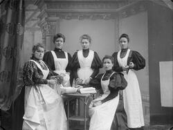 gruppe, kvinner, forklær, kjøkkenutstyr, kokebok