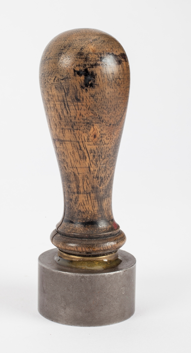 Norges riksvåpen, løve med øks og krone på ett skjold med krone over. På hver side er symbolet med hammer og feisel i kryss.