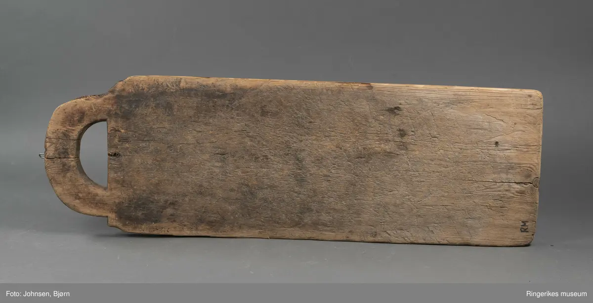 Vaskebrett i furu med kvadrater skråskjært i vekselsvis motsatt retning, sånn at rillene går i begge retninger. Håndtak øverst.