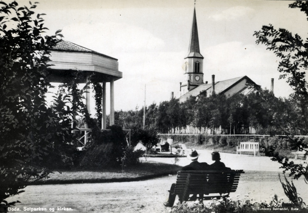 Postkort med motiv fra Bodø. Solparken med Bodø kirke i bakgrunnen.