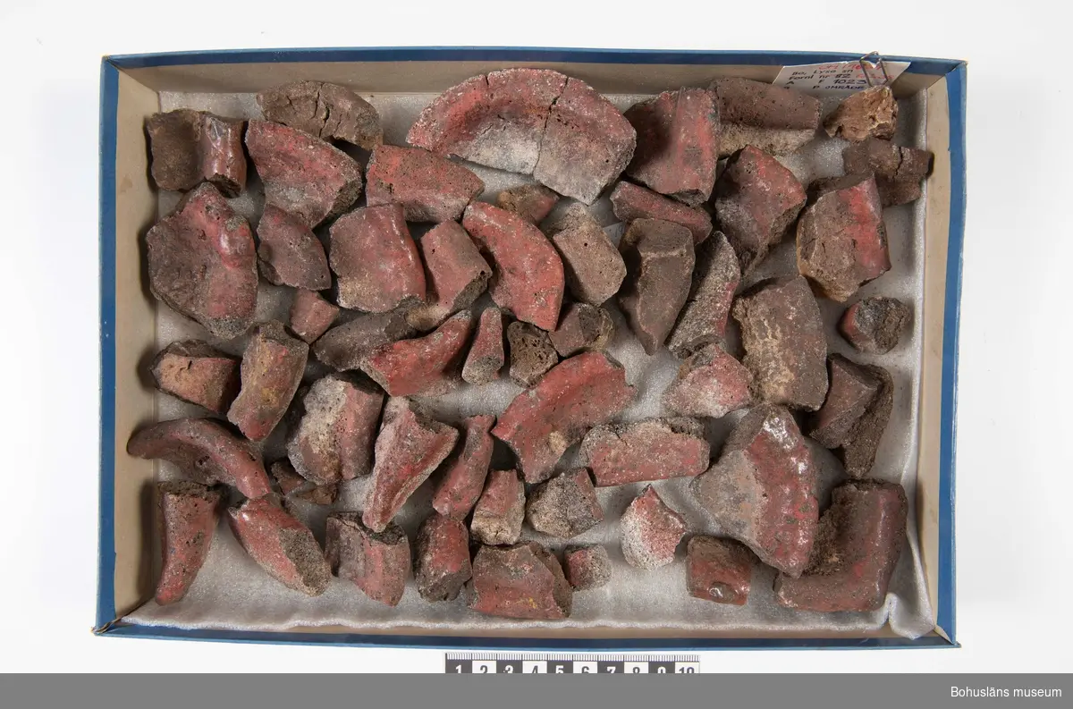 En hel komplett degel (sammansatt av två delar) och ett femtiotal fragment. Delvis rödaktig sintrad yta. Ljusgrått hårbränt kompakt gods. Delvis sintrade ytor. Degeln använd vid gjutning av bronsföremål.

294 Landskap BOHUSLÄN