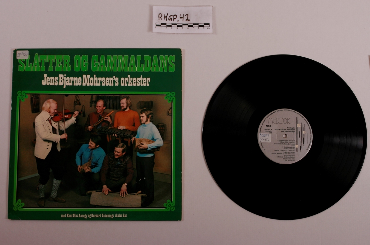 Grammofonplate i svart vinyl og plateomslag i papp. Plata ligger i en papirlomme.