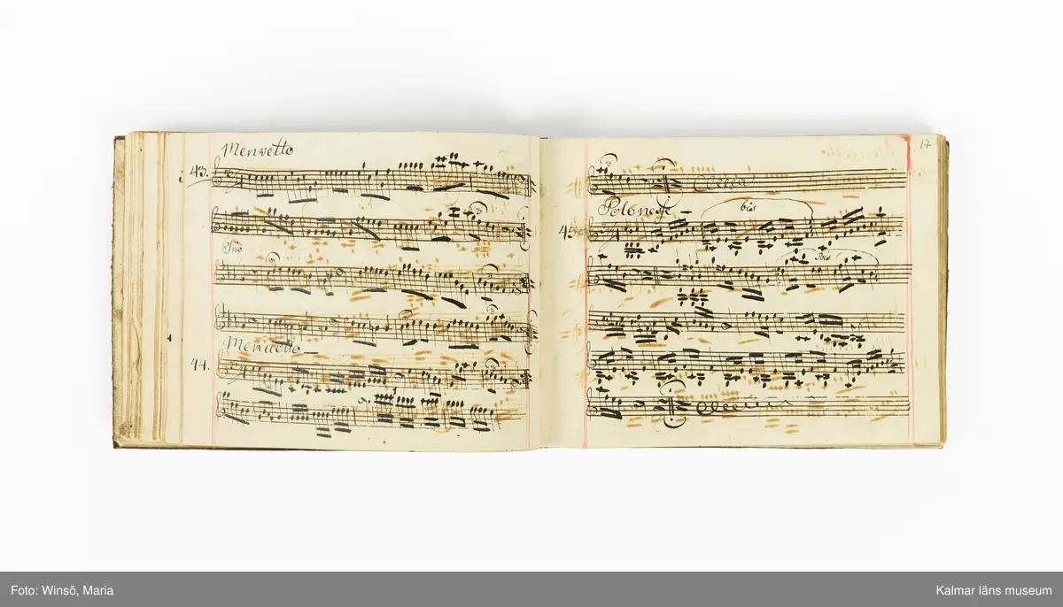 KLM 21071. Notbok, handskrift. Tvärformat. Helt skinnband med marmorering samt guldpräglade dekorelement. På pärmens framsida: VIOLINO PRIMO. På försättsbladet: I:N:J:C. samt Adam Lorentz Stålhammar ao 1773. Därefter handskrivna kompositioner, menuetter.