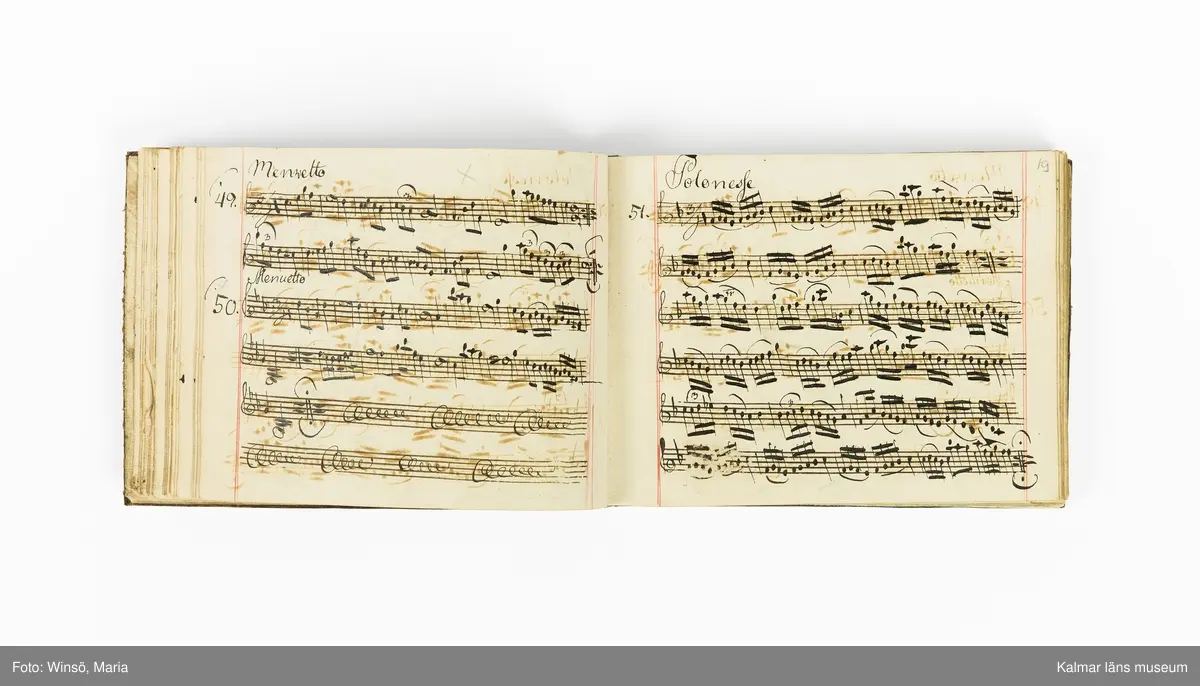 KLM 21071. Notbok, handskrift. Tvärformat. Helt skinnband med marmorering samt guldpräglade dekorelement. På pärmens framsida: VIOLINO PRIMO. På försättsbladet: I:N:J:C. samt Adam Lorentz Stålhammar ao 1773. Därefter handskrivna kompositioner, menuetter.