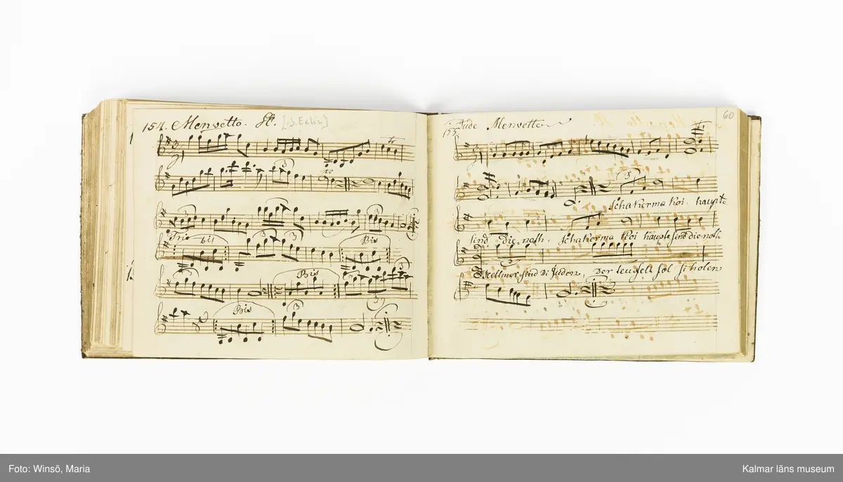 KLM 21071. Notbok, handskrift. Tvärformat. Helt skinnband med marmorering samt guldpräglade dekorelement. På pärmens framsida: VIOLINO PRIMO. På försättsbladet: I:N:J:C. samt Adam Lorentz Stålhammar ao 1773. Därefter handskrivna kompositioner, menuetter.