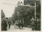 Häst och vagn vid mållinjen under biltävling.
Fotografi från John Neréns motorhistoriska samling.