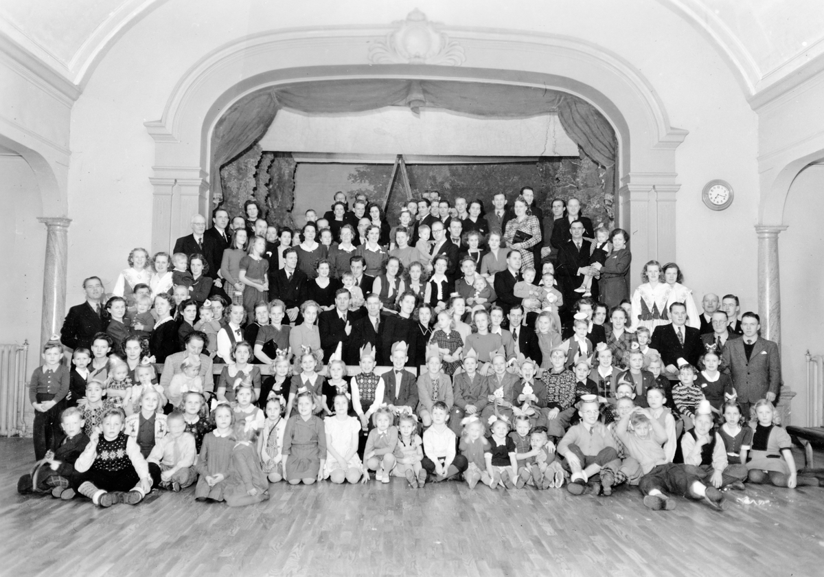 Gruppfoto på och framför en scen.