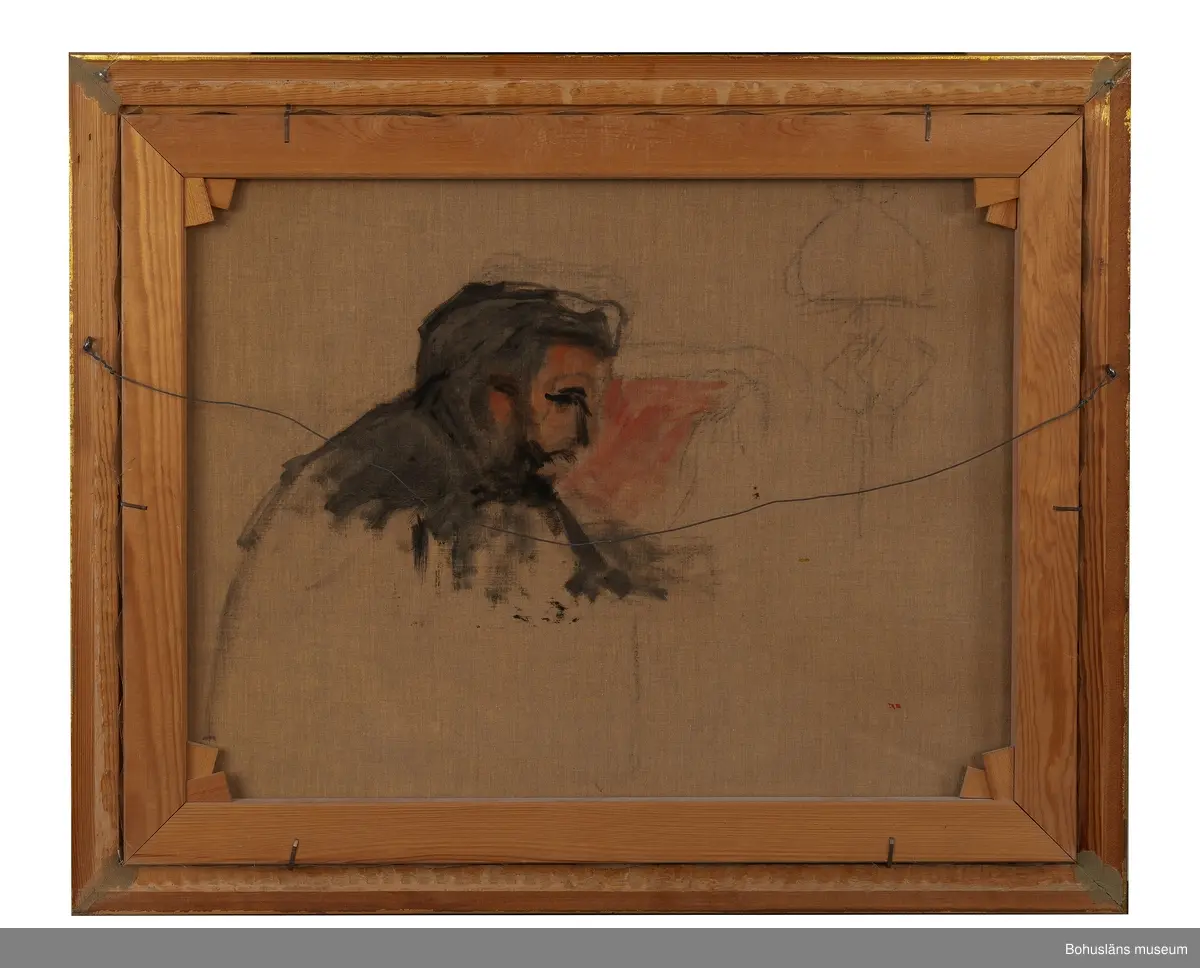 Skrivbordsporträtt av Alfred Grenander vid sitt skrivbord i skenet av en fotogenlampa.